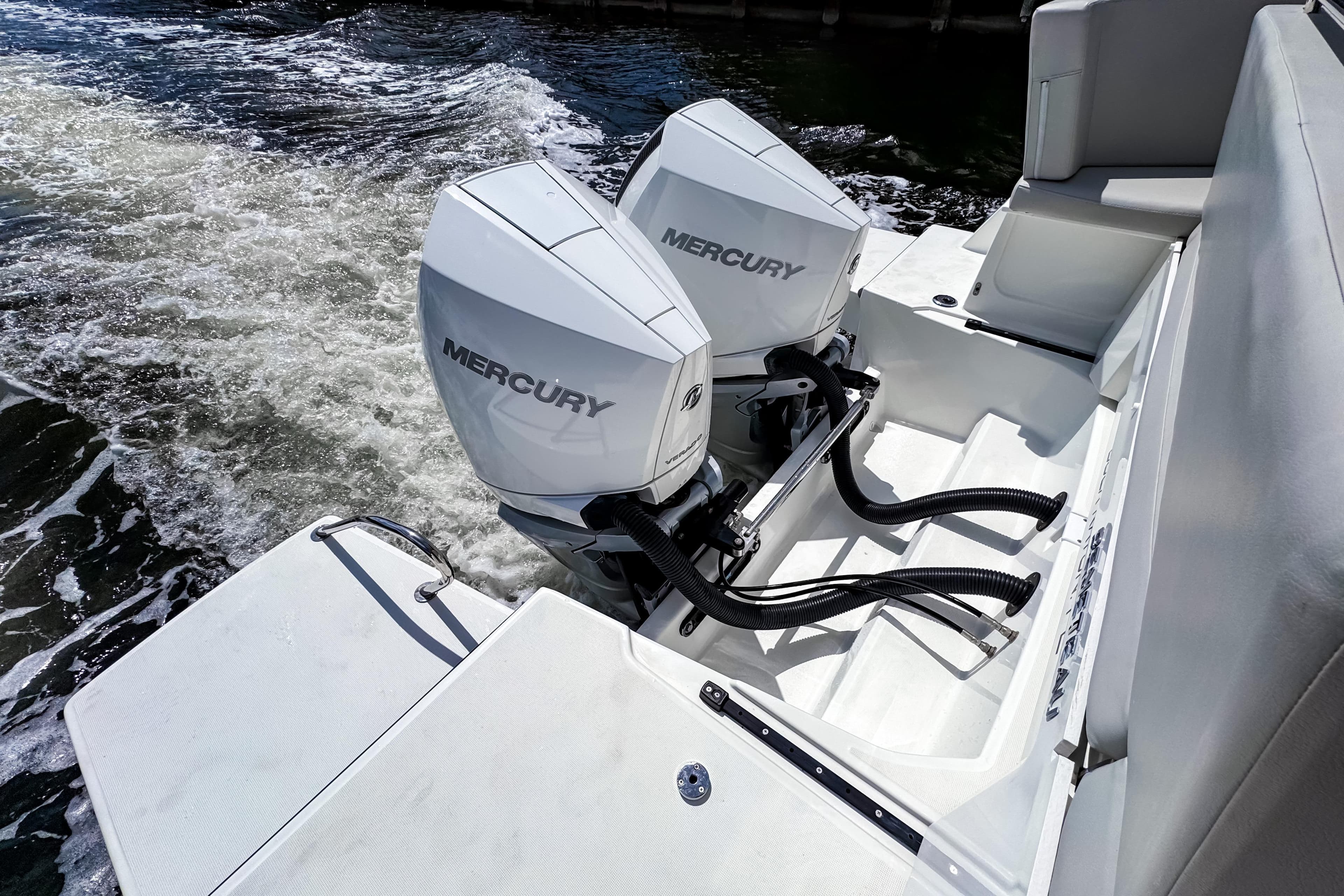 2023 Beneteau Antares 11 with dual Mercury outboard engines on water.