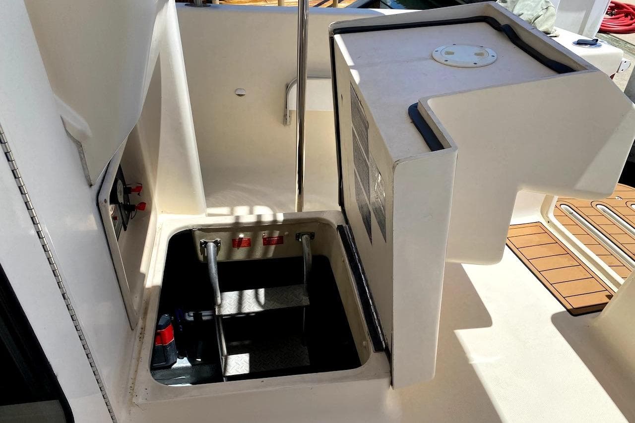 2005 Mainship 34 Trawler engine compartment with open hatch and visible ladder.