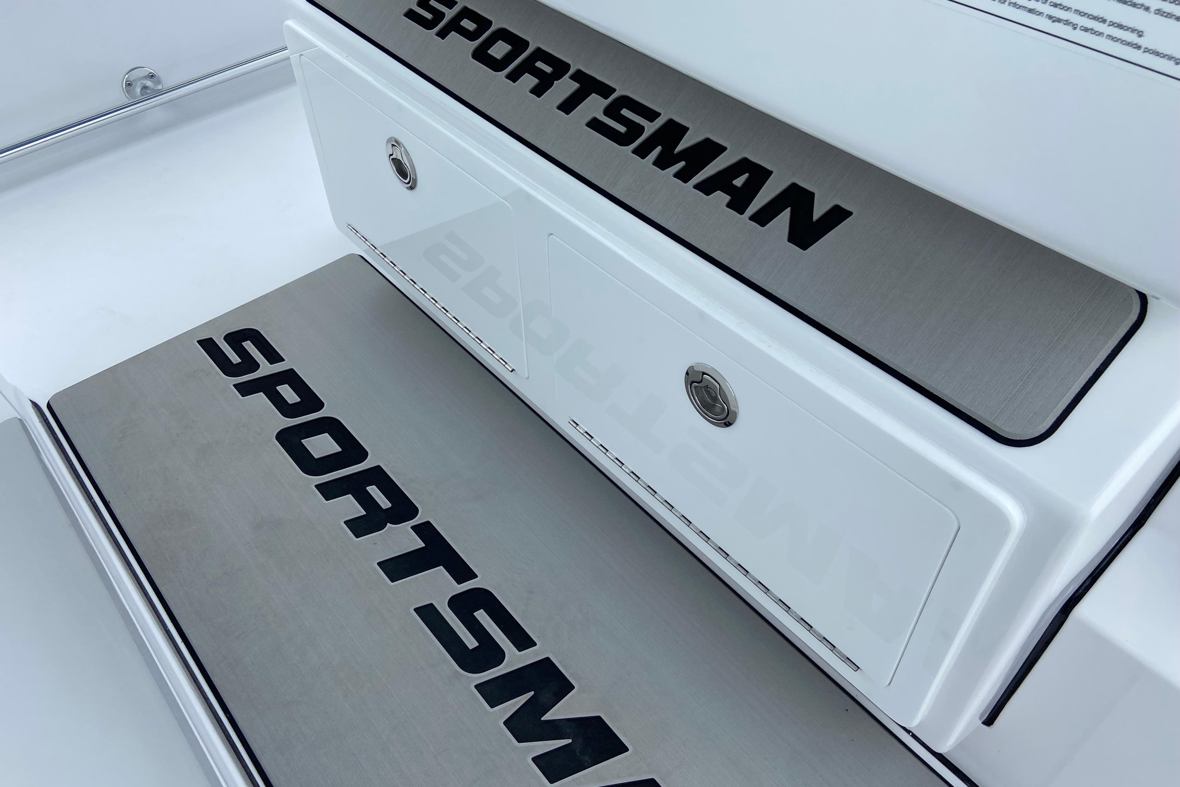 2026 Sportsman Open 302 Center Console boat deck with branded storage compartments.
