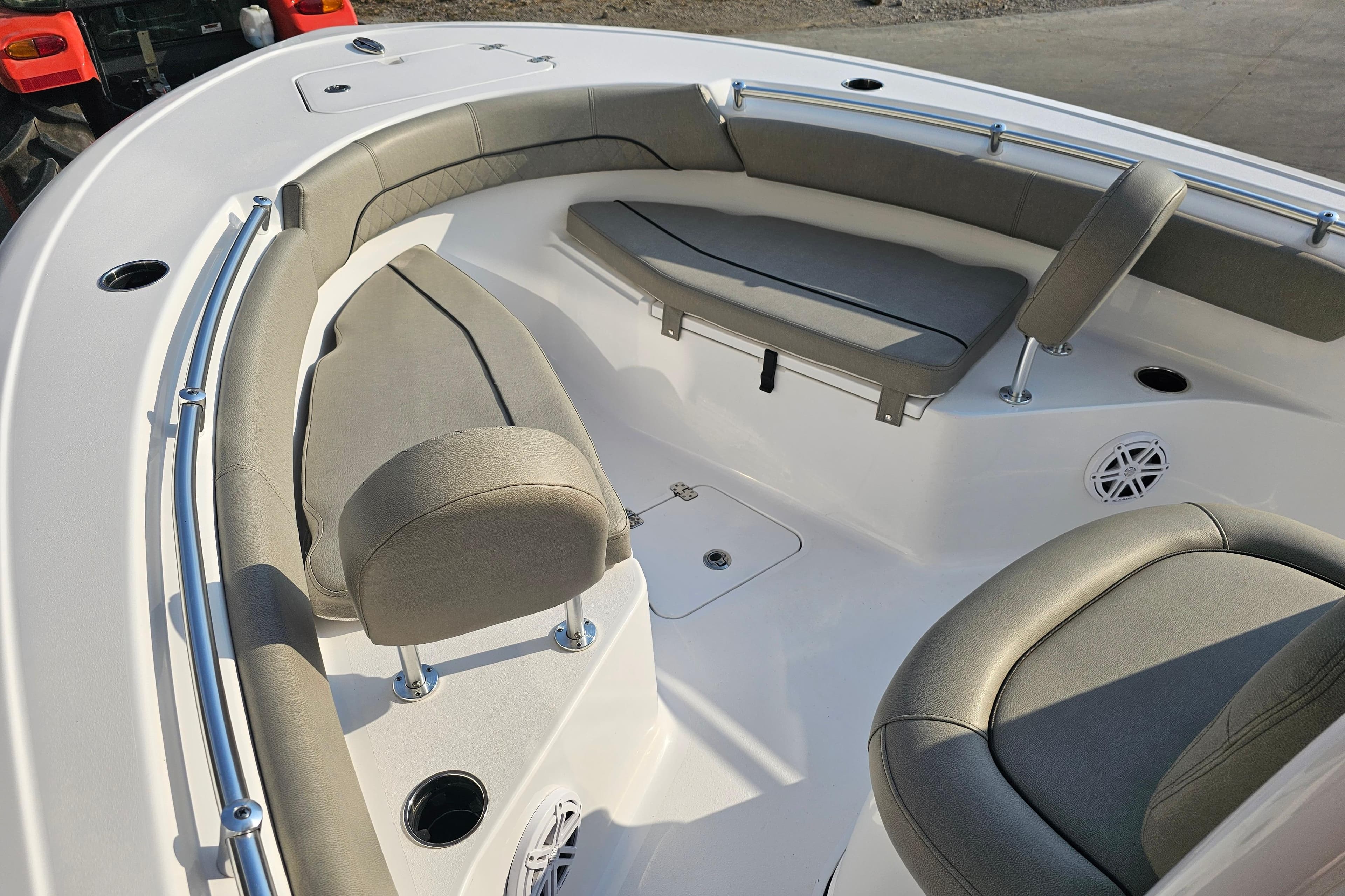 2023 Sportsman Open 212 Center Console boat interior with cushioned seating and cup holders.