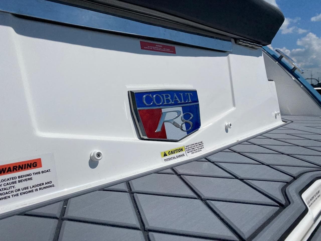 Cobalt R8 2022 model boat with logo and warning labels on deck.