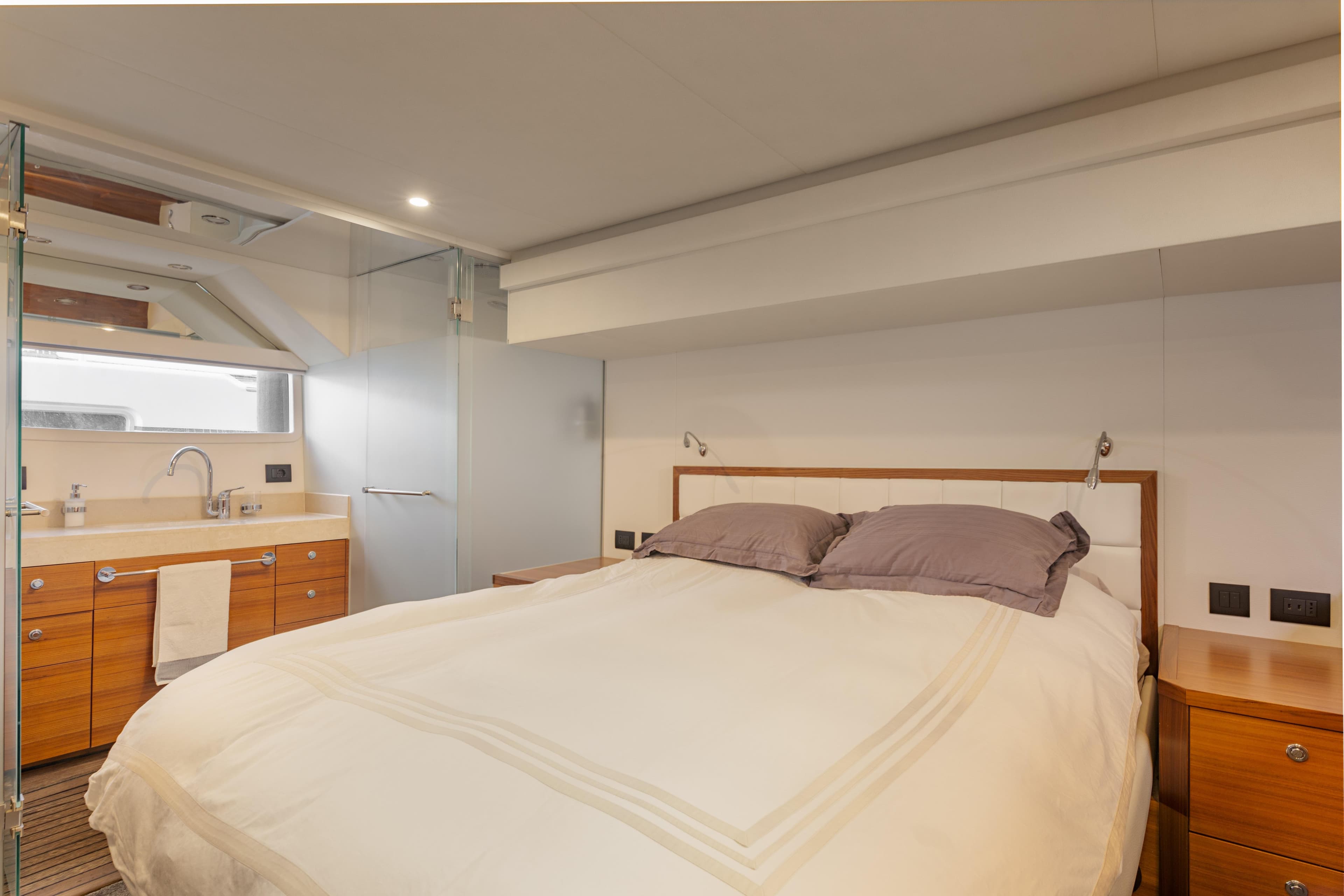 Luxurious bedroom interior of 2016 Outer Reef Trident 620 yacht with modern amenities.