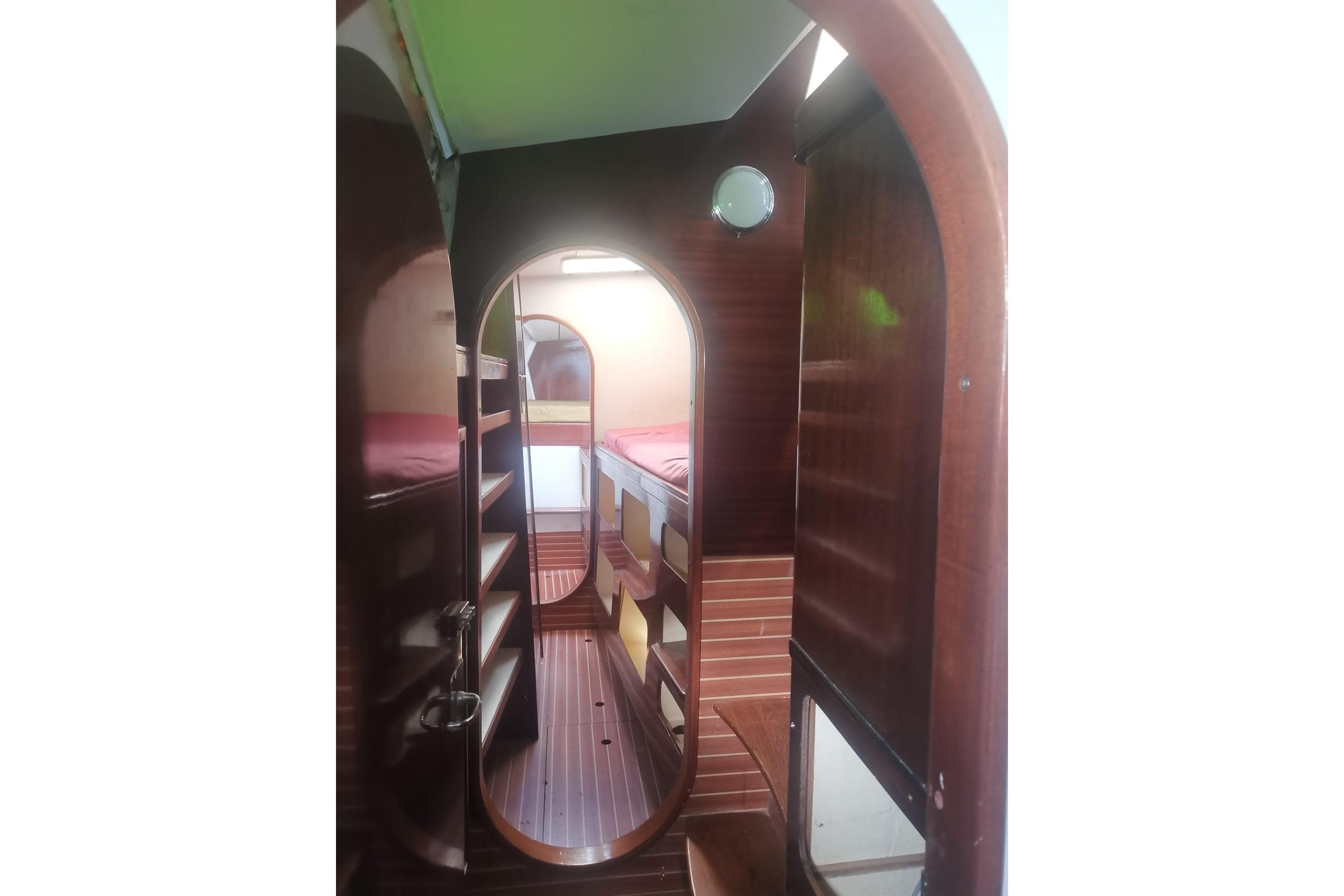 Interior of 1992 Catana 40S yacht, featuring wooden cabinetry and cozy sleeping quarters.