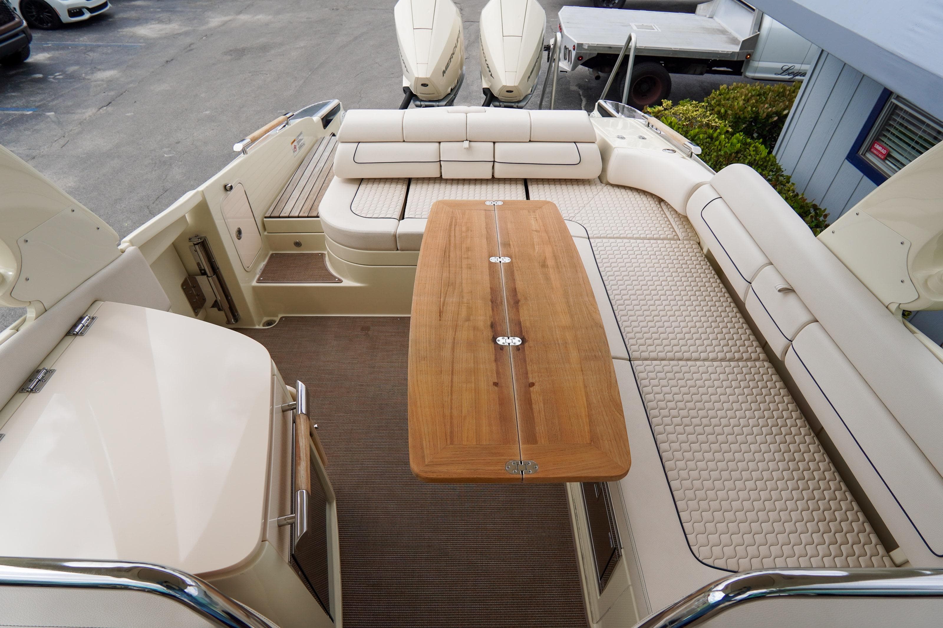 Luxurious interior of 2024 Chris-Craft Launch 31 GT boat with elegant seating and wooden table.