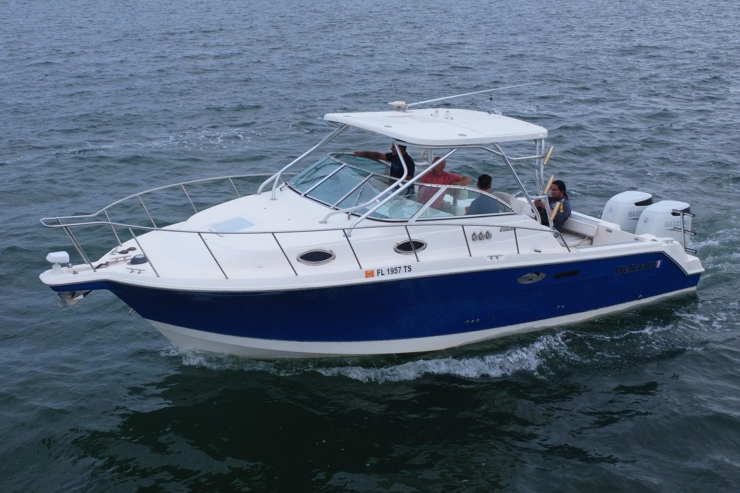 2001 Wellcraft 290 Coastal boat cruising on open water with passengers onboard.