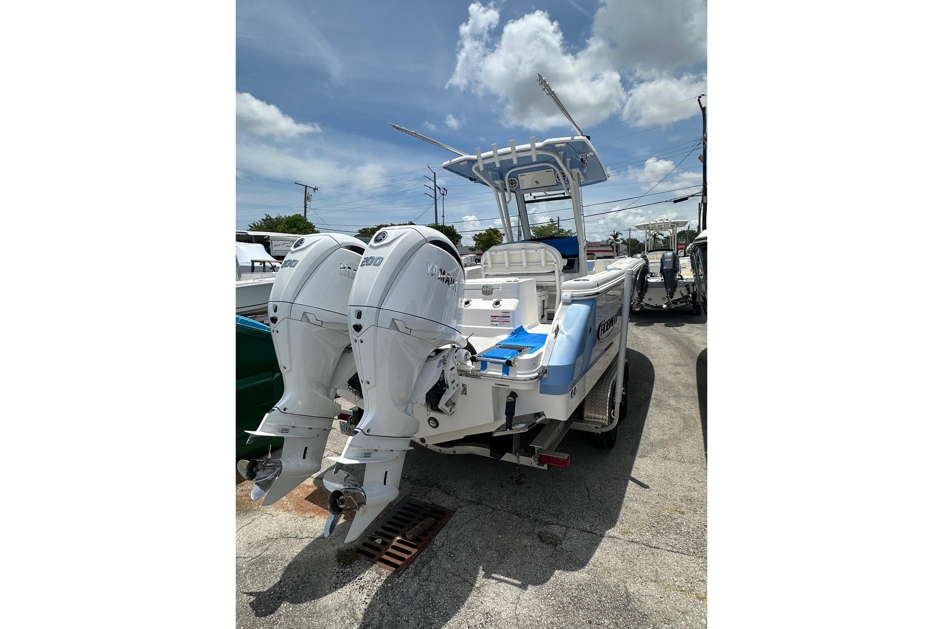 2024 Robalo R250 Center Console boat with dual Yamaha outboard engines, parked outdoors.