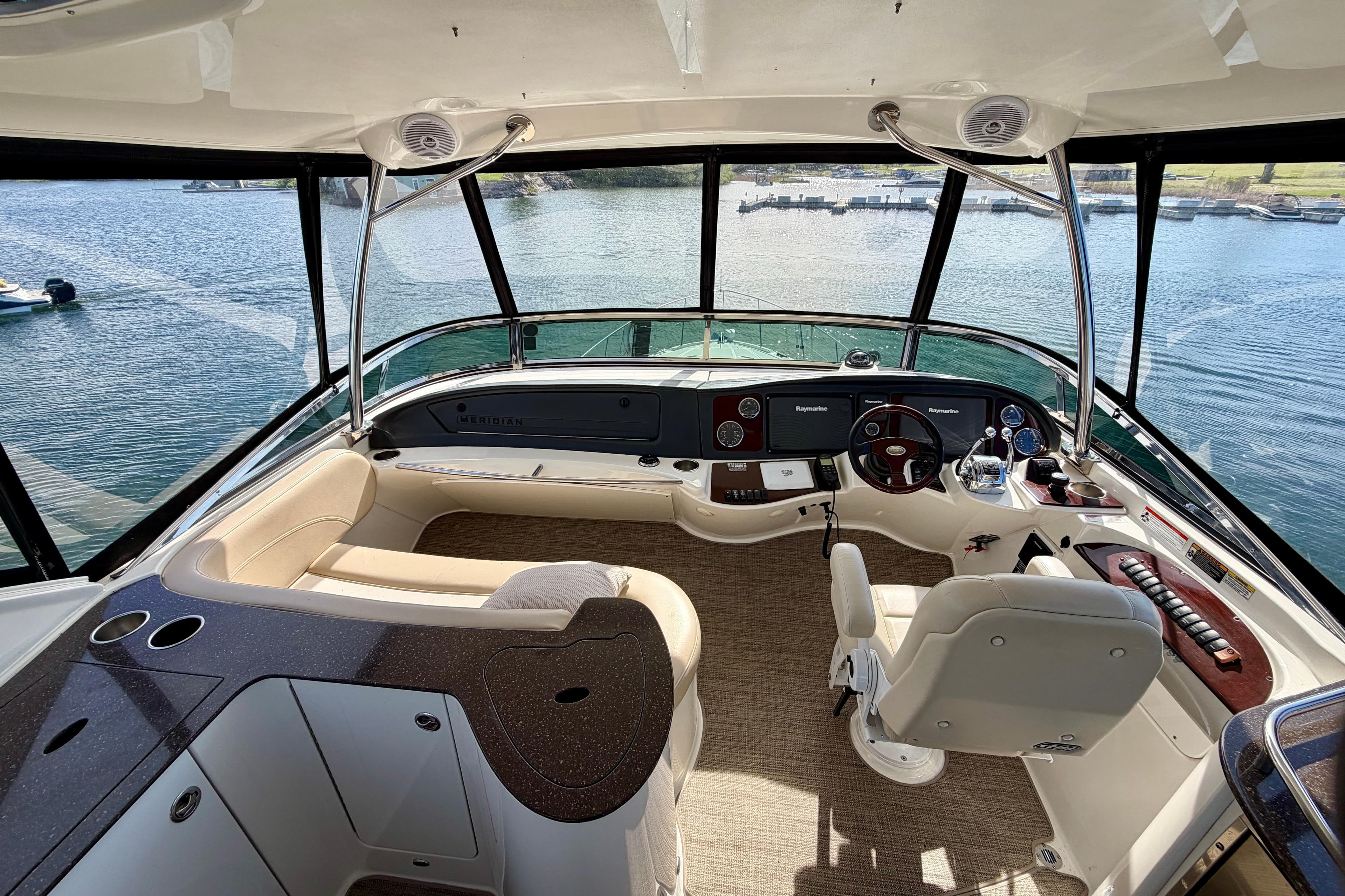 Cockpit of 2011 Meridian 441 Sedan yacht with panoramic water view.