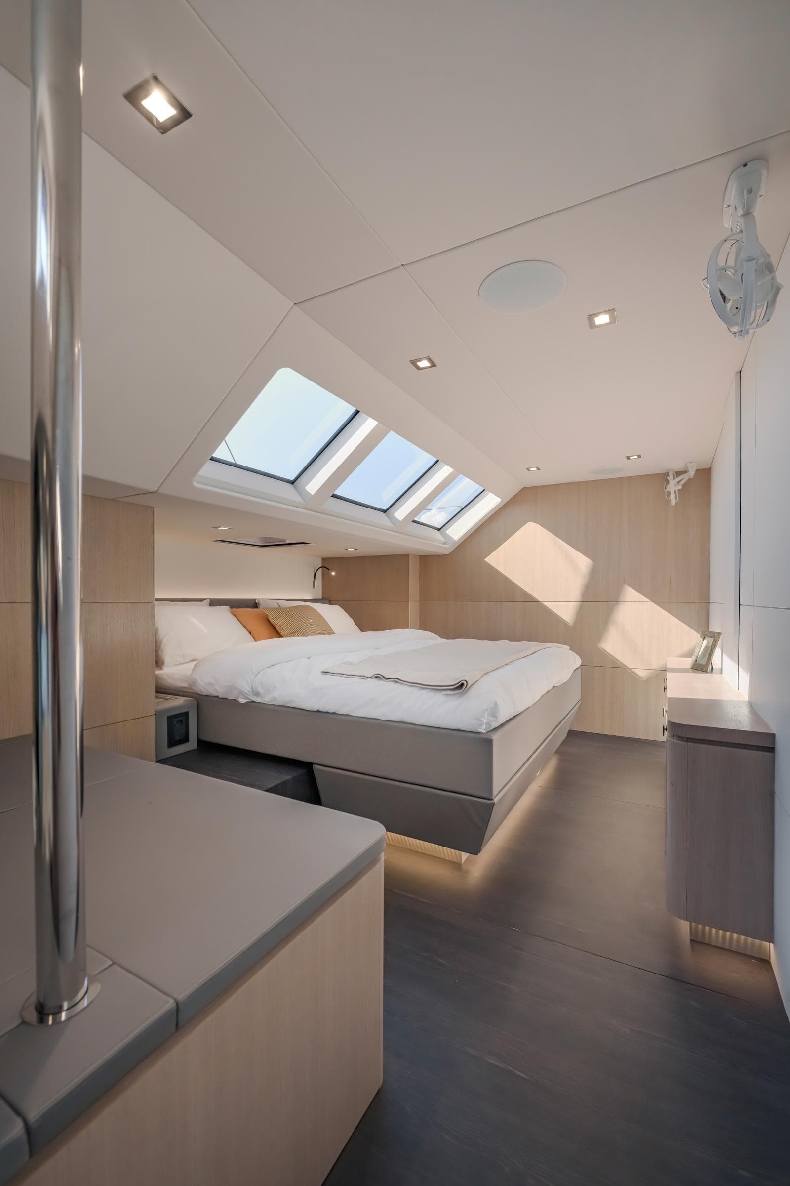 Luxurious bedroom interior of 2025 Privilege Signature 650 yacht with skylights and modern design.