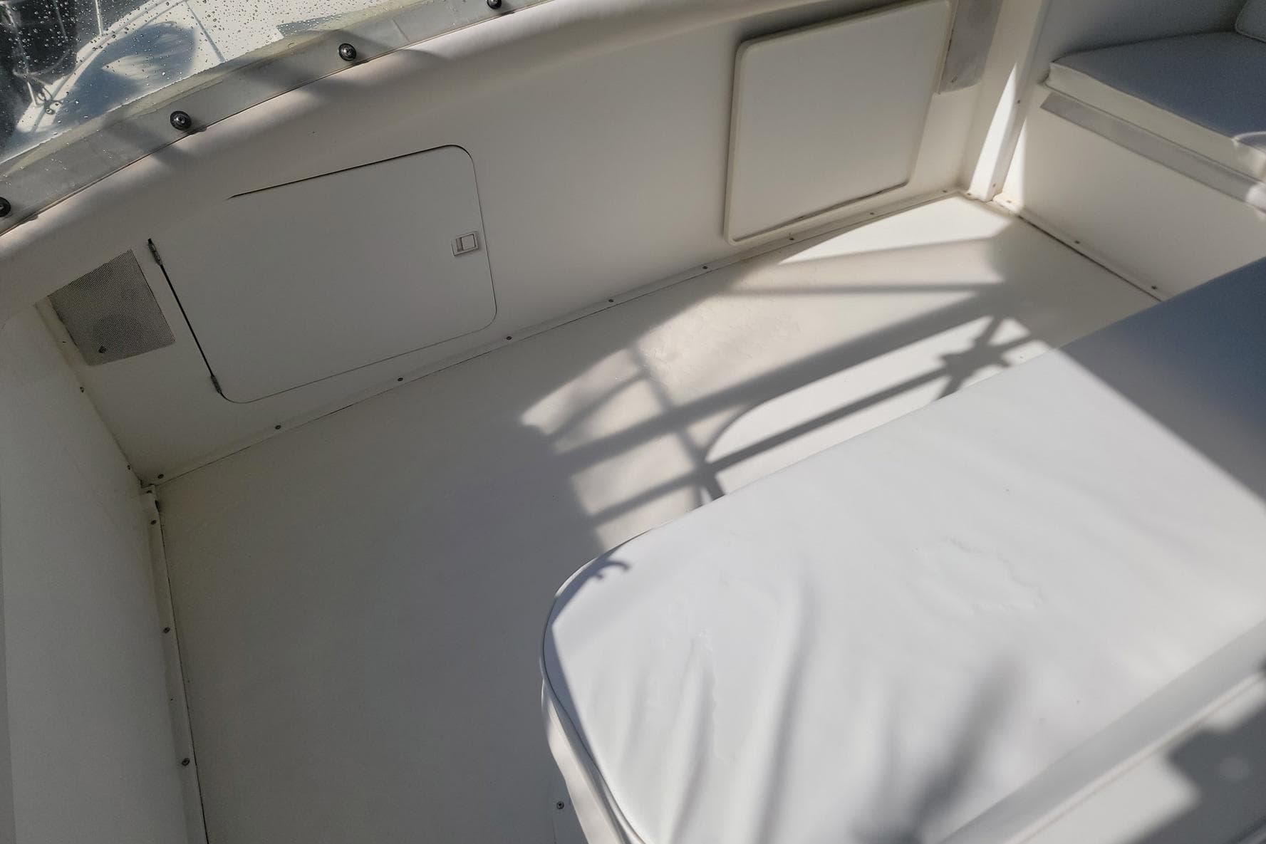 1989 Bertram 50 Convertible boat interior with white seating and storage compartments.