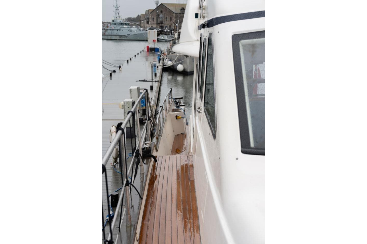 Side view of 2007 Aquastar 57 yacht docked at a marina.