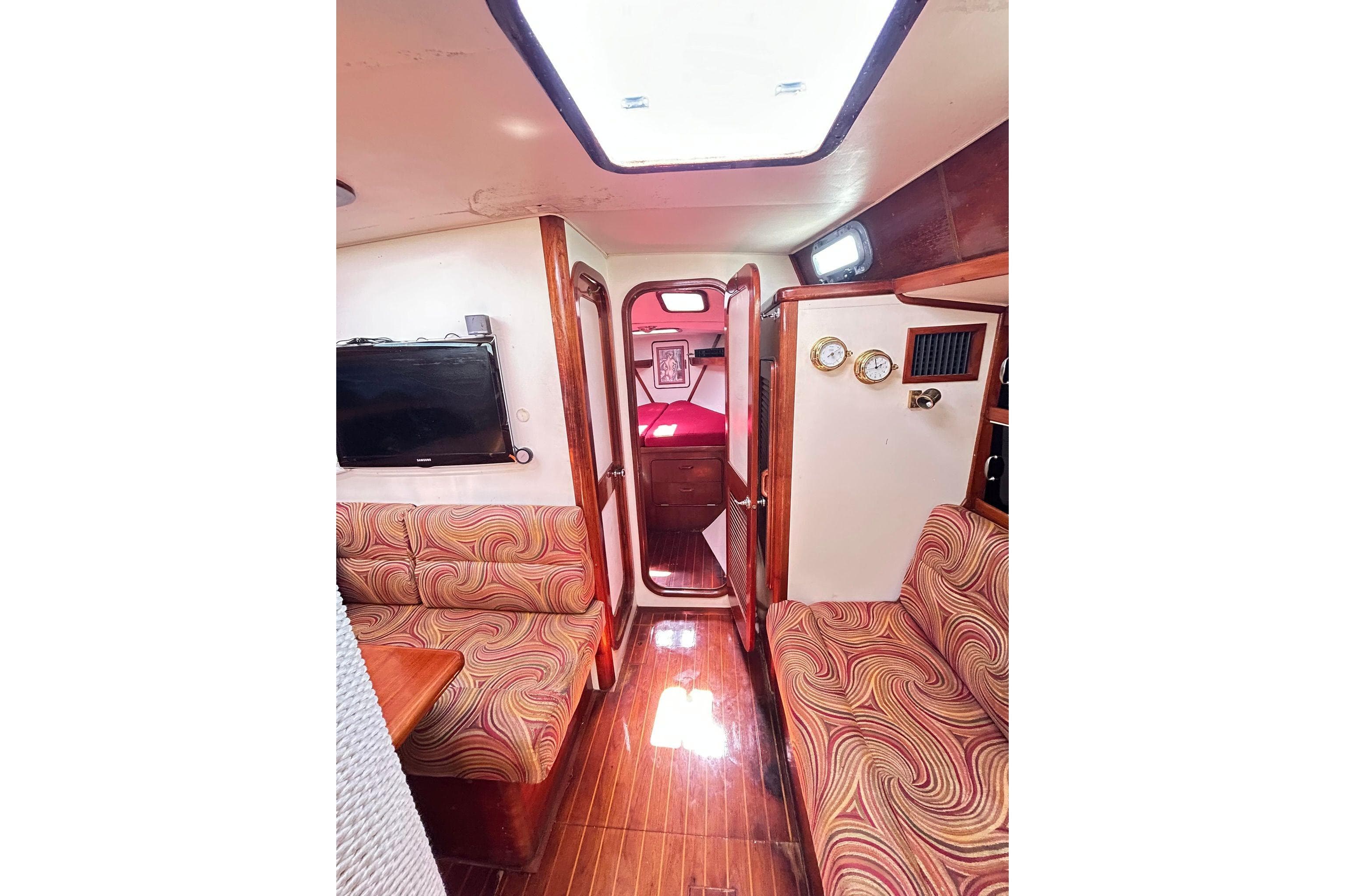 Interior of 1987 Gulfstar CSY 50 Pilot House with patterned seating and wood accents.