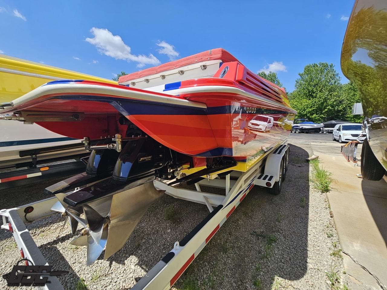 Red 2004 Sonic USA 45SS speedboat on trailer, sunny day, vibrant colors.