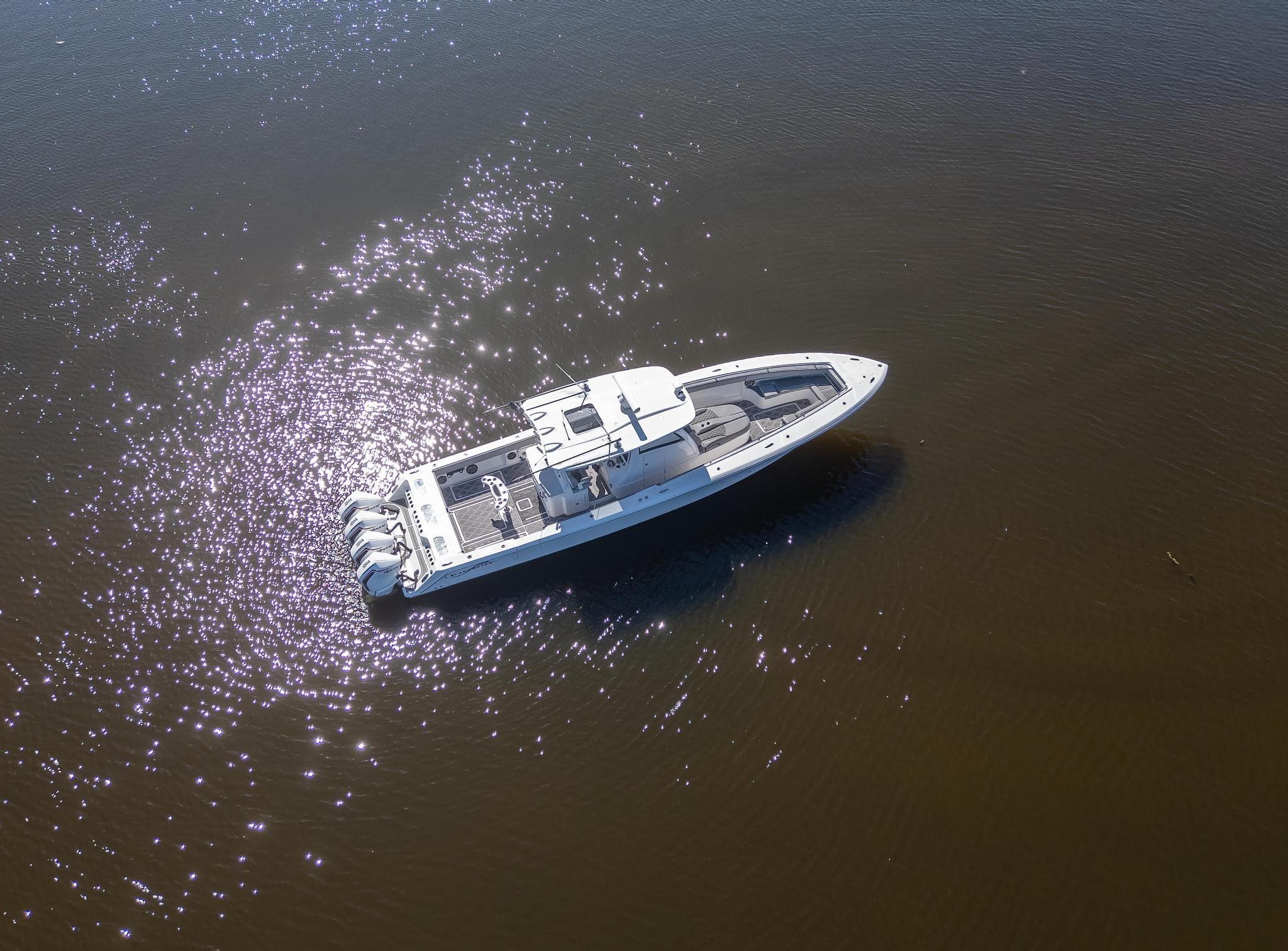 Aerial view of 2020 Blackwater 43 Sportfish boat on shimmering water.