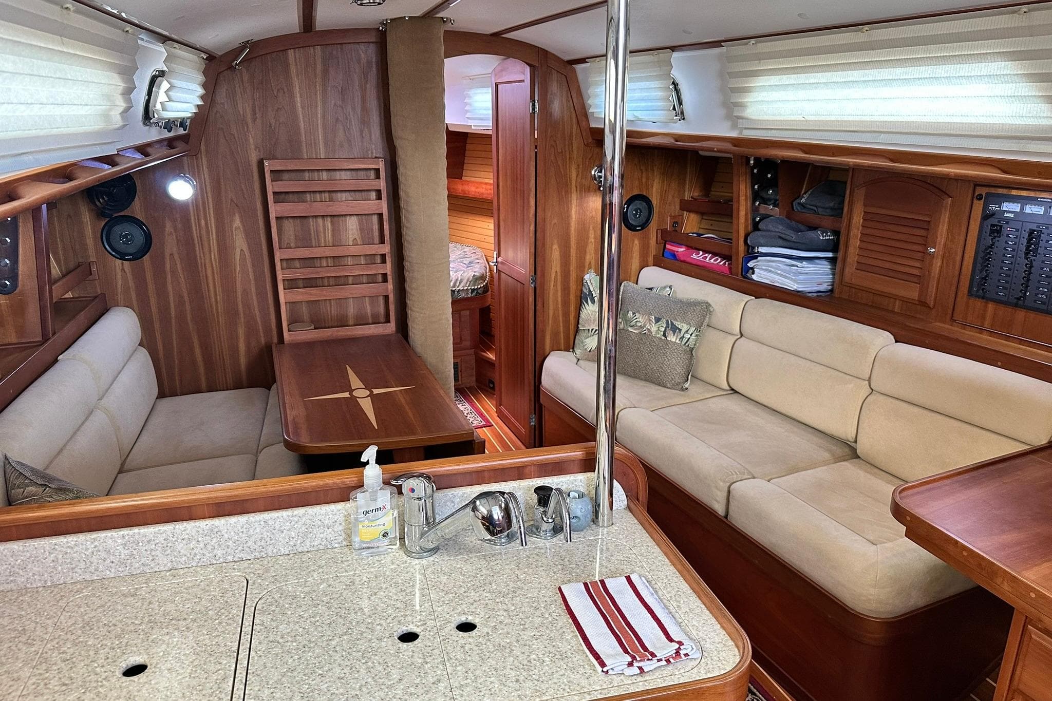 Luxurious 2007 Sabre 386 yacht interior with cozy seating and elegant wood finishes.