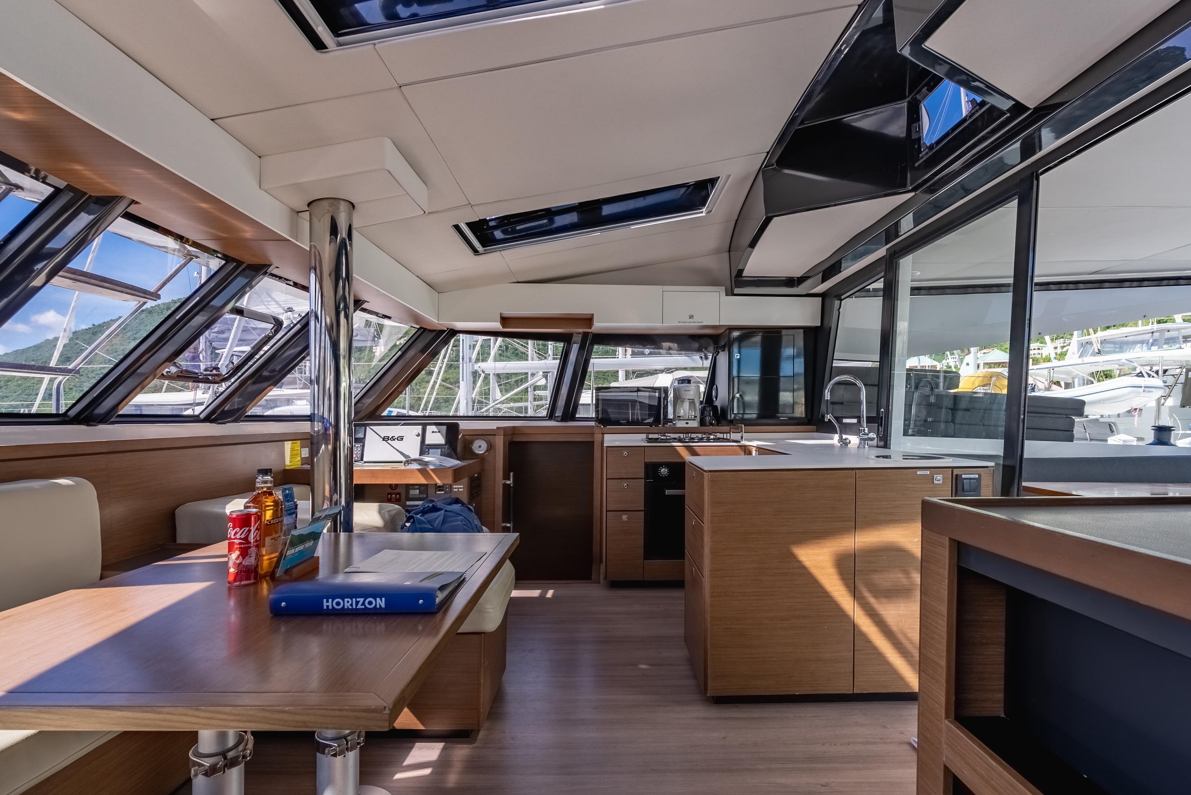 Interior of 2022 Nautitech 46 Fly catamaran, featuring modern kitchen and dining area.
