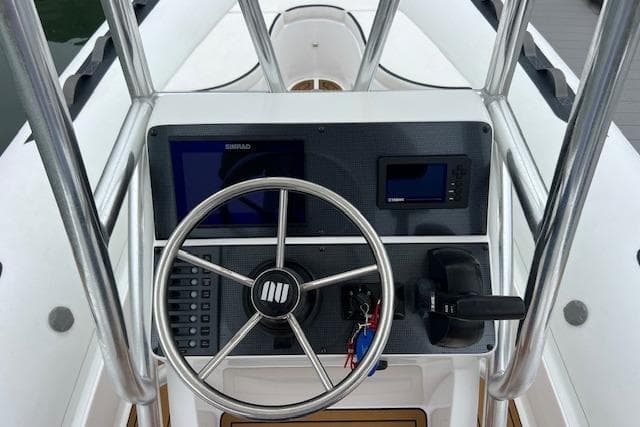 2023 Novurania Como 18 boat dashboard with steering wheel and navigation controls.