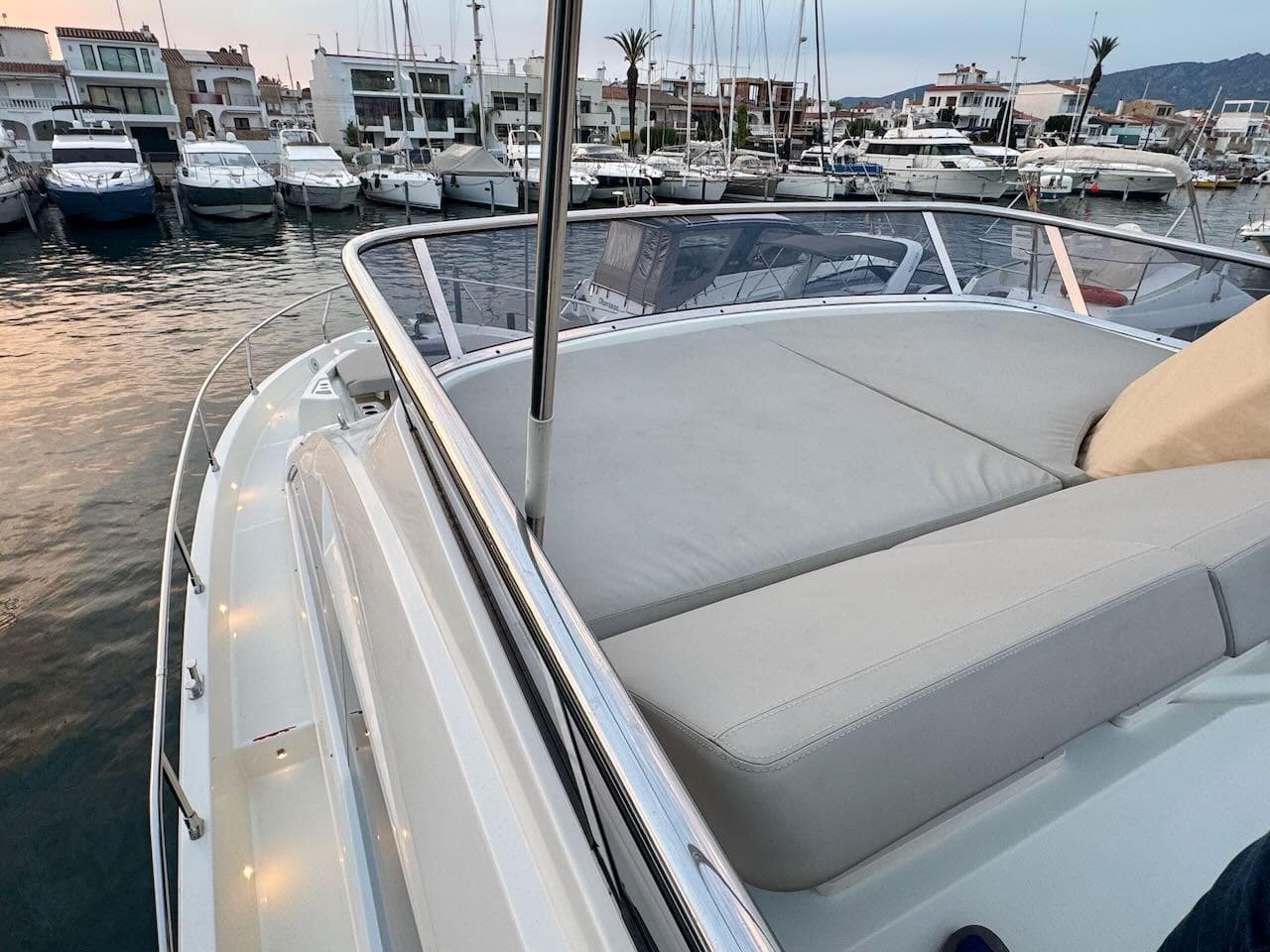 2017 Cranchi E 52 F yacht with spacious deck in marina setting.