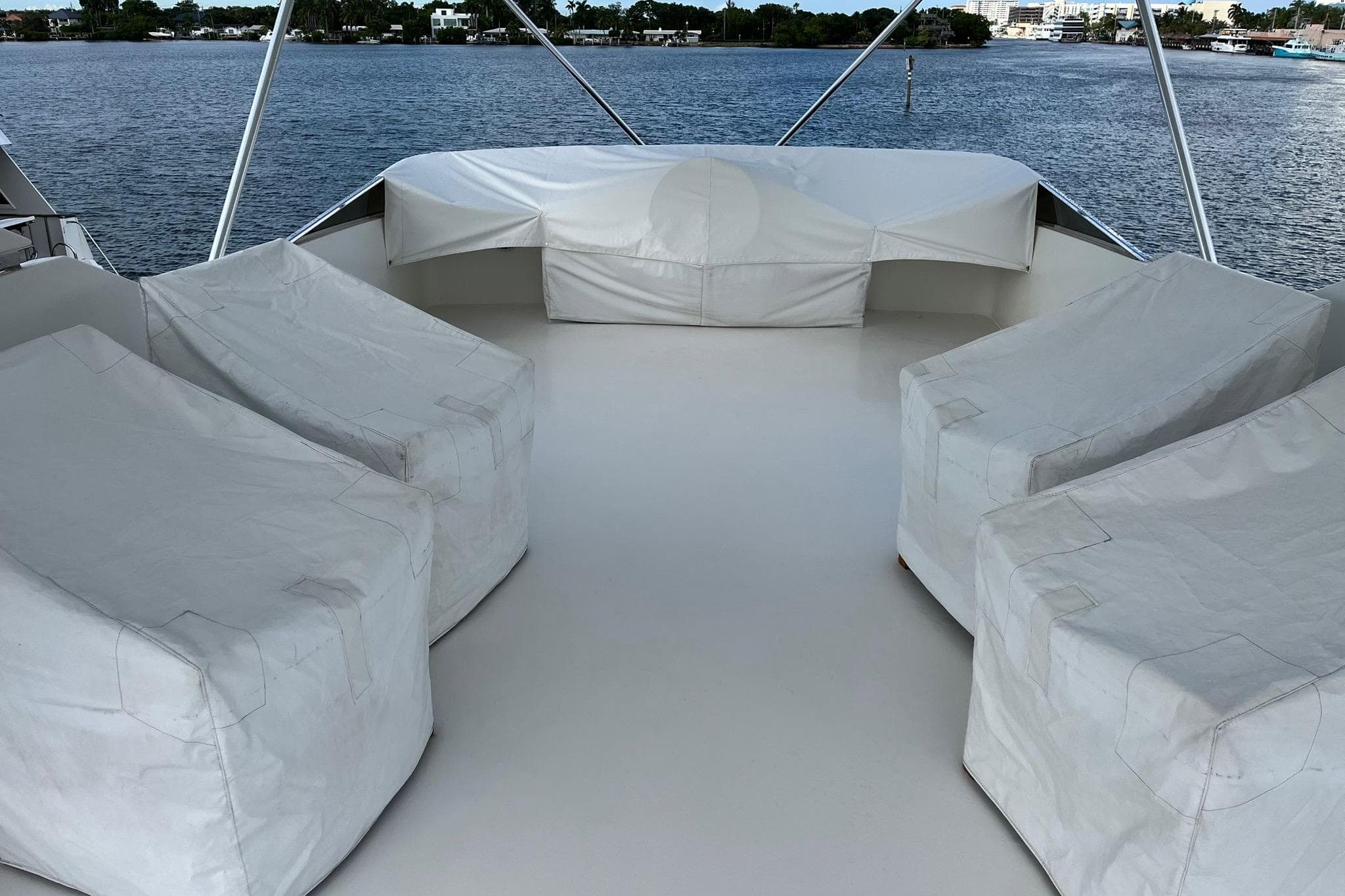 1996 Hershine Benship 87 yacht deck with covered seating, overlooking calm waters.