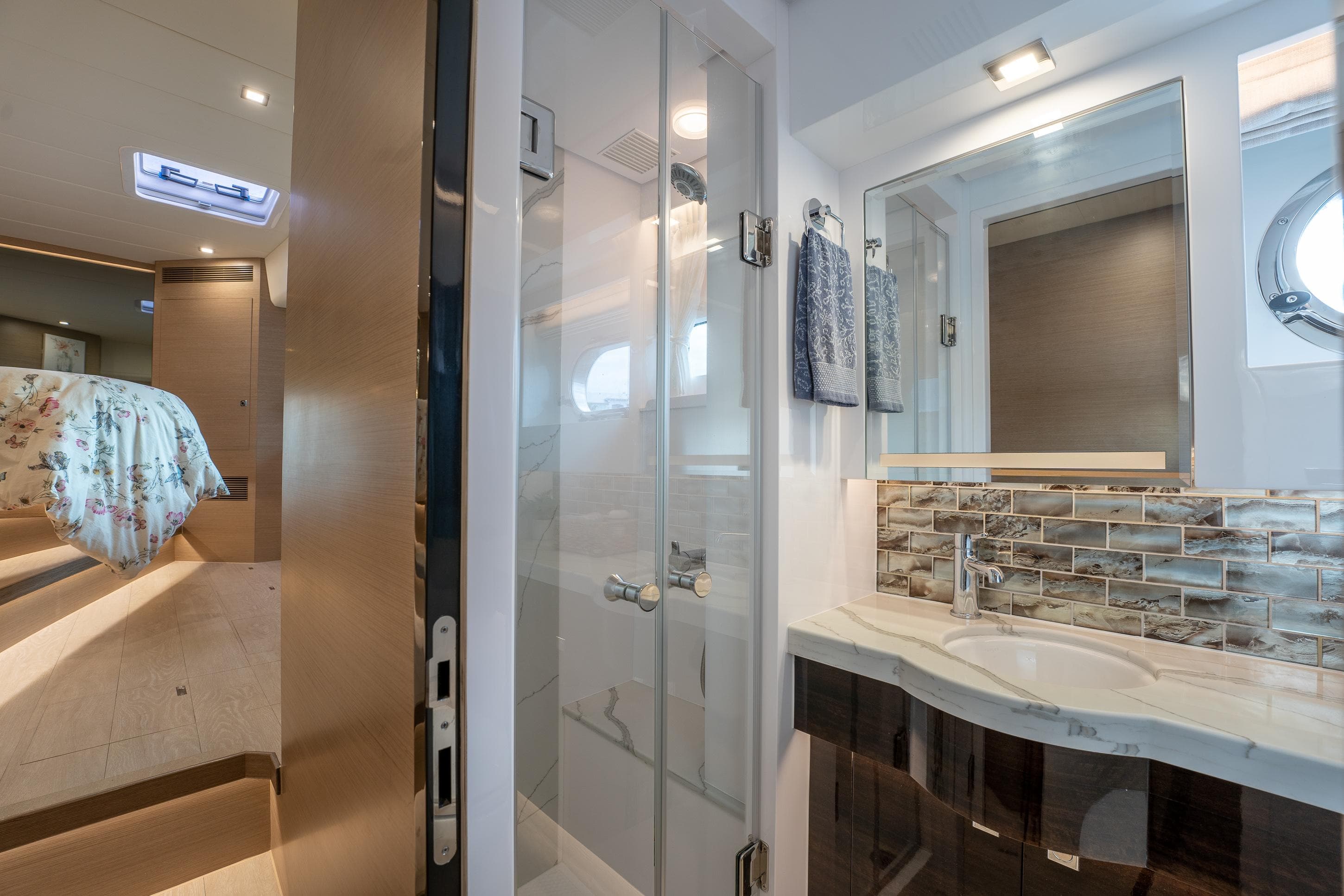 Luxurious Horizon PC60 2020 yacht bathroom with modern shower and elegant sink area.