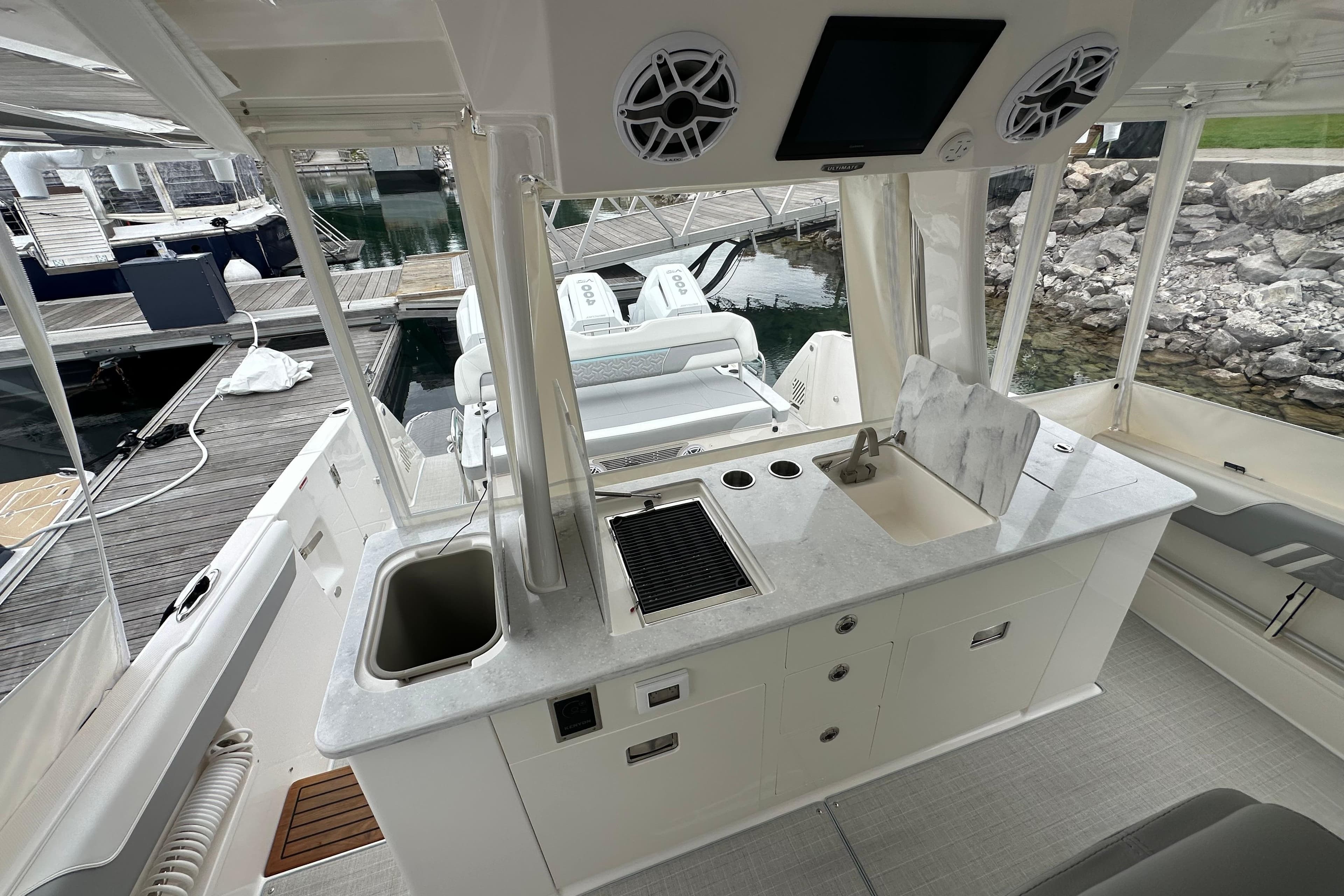 2026 Regal 38 SAV boat interior with modern kitchenette and dock view.