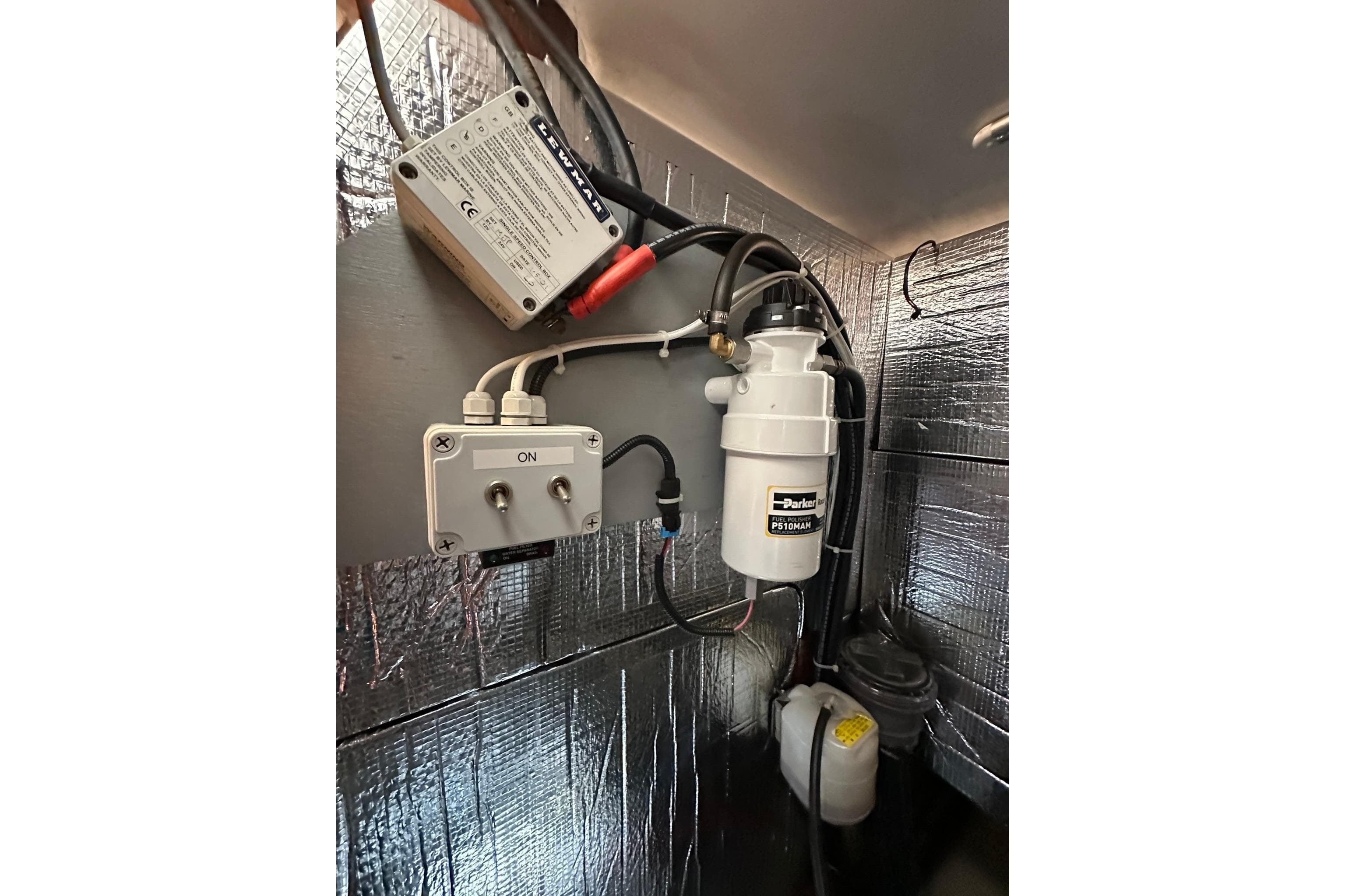 Engine compartment of a 2000 Beneteau 50 yacht with fuel filter and electrical components.