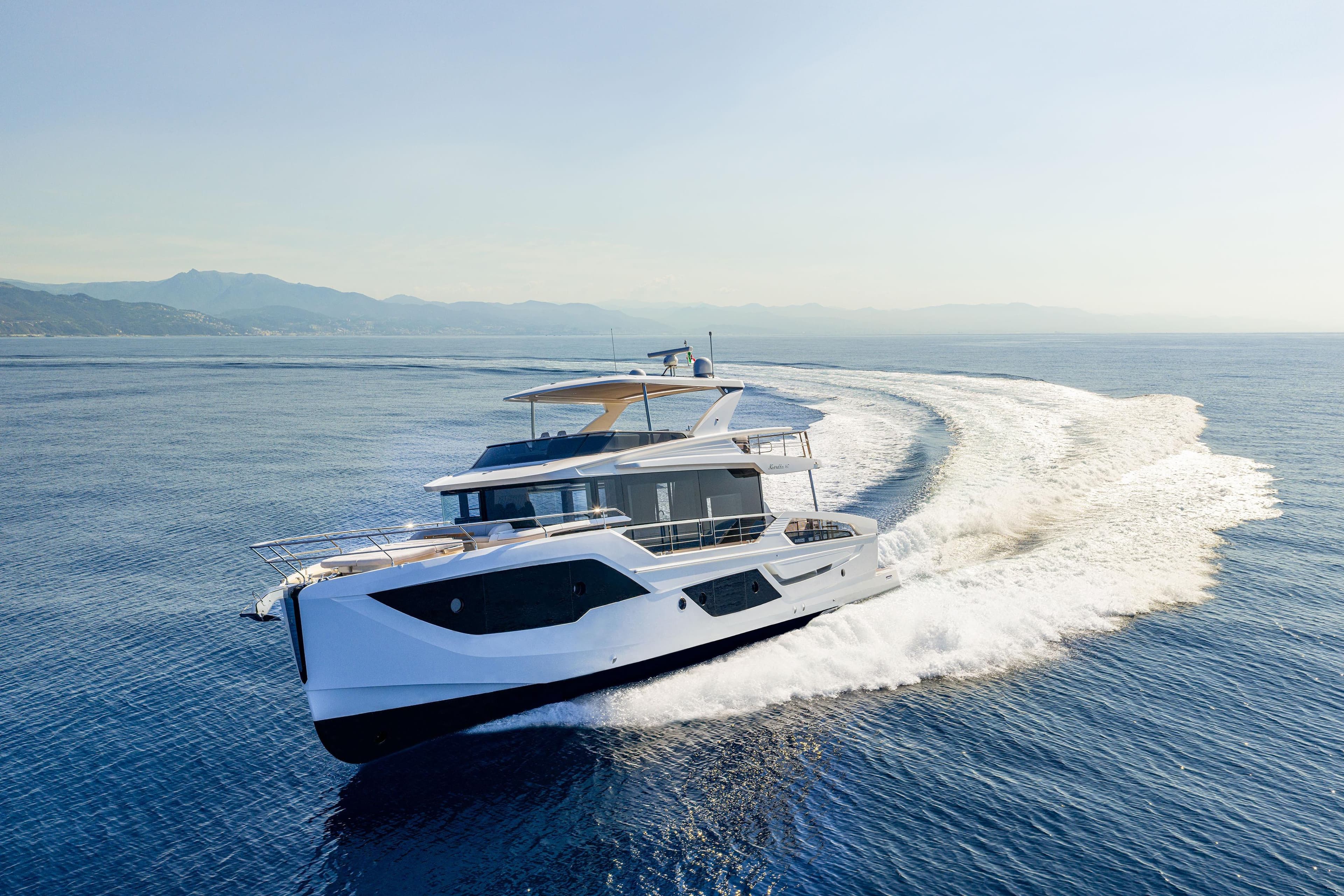 Luxurious 2026 Absolute 62' Navetta yacht cruising on open sea, creating a dynamic wake.