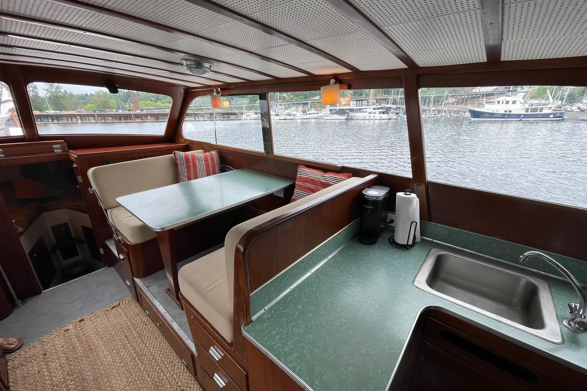 Interior of a 1948 Grandy 34 boat with dining area and kitchenette.