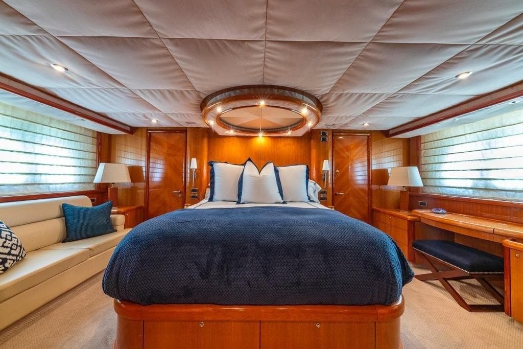 Luxurious bedroom interior of 2003 Sunseeker 82 Yacht with elegant wood finishes.