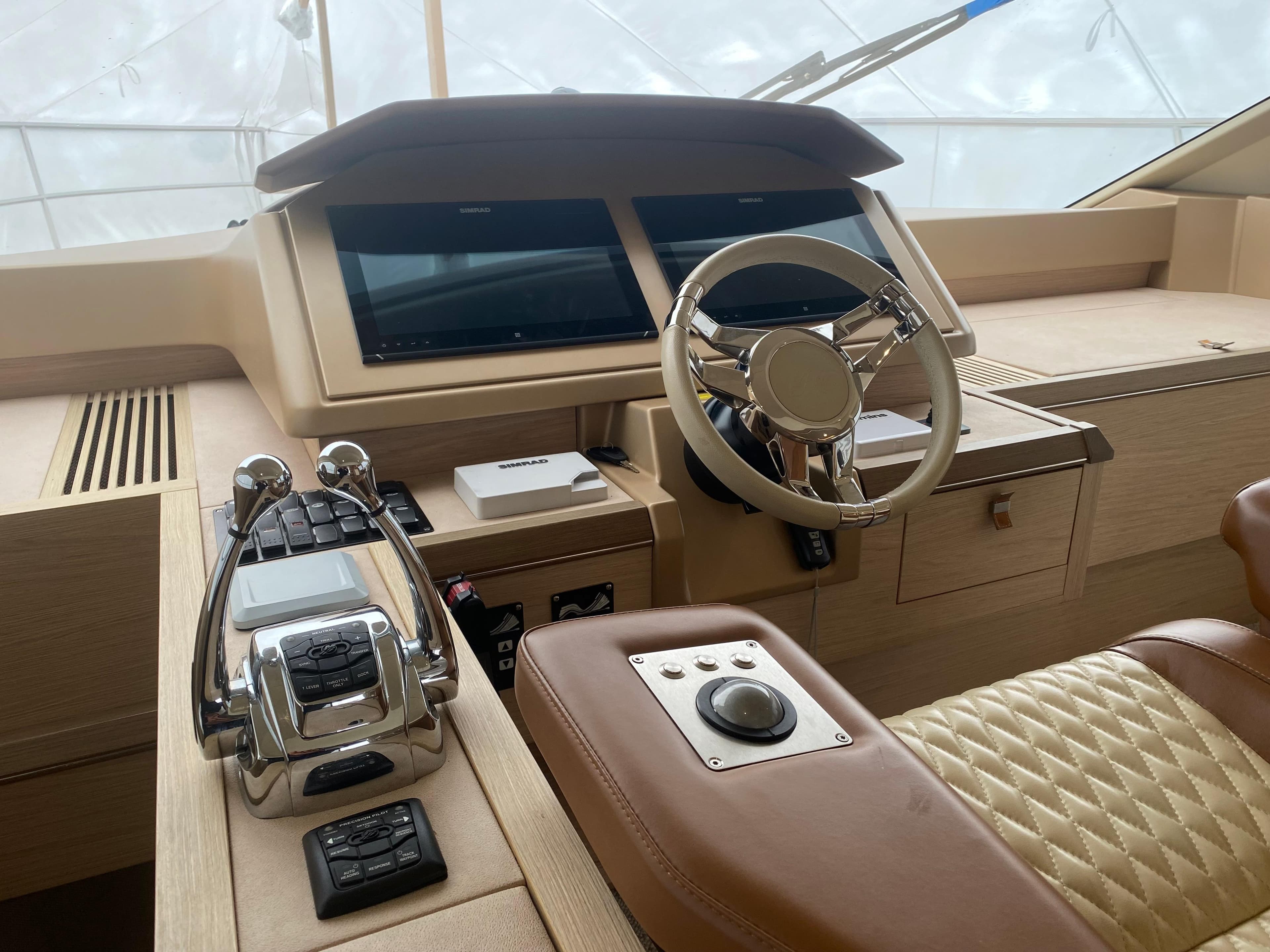 2017 Beneteau Monte Carlo MC6 helm with modern controls and luxurious leather seating.