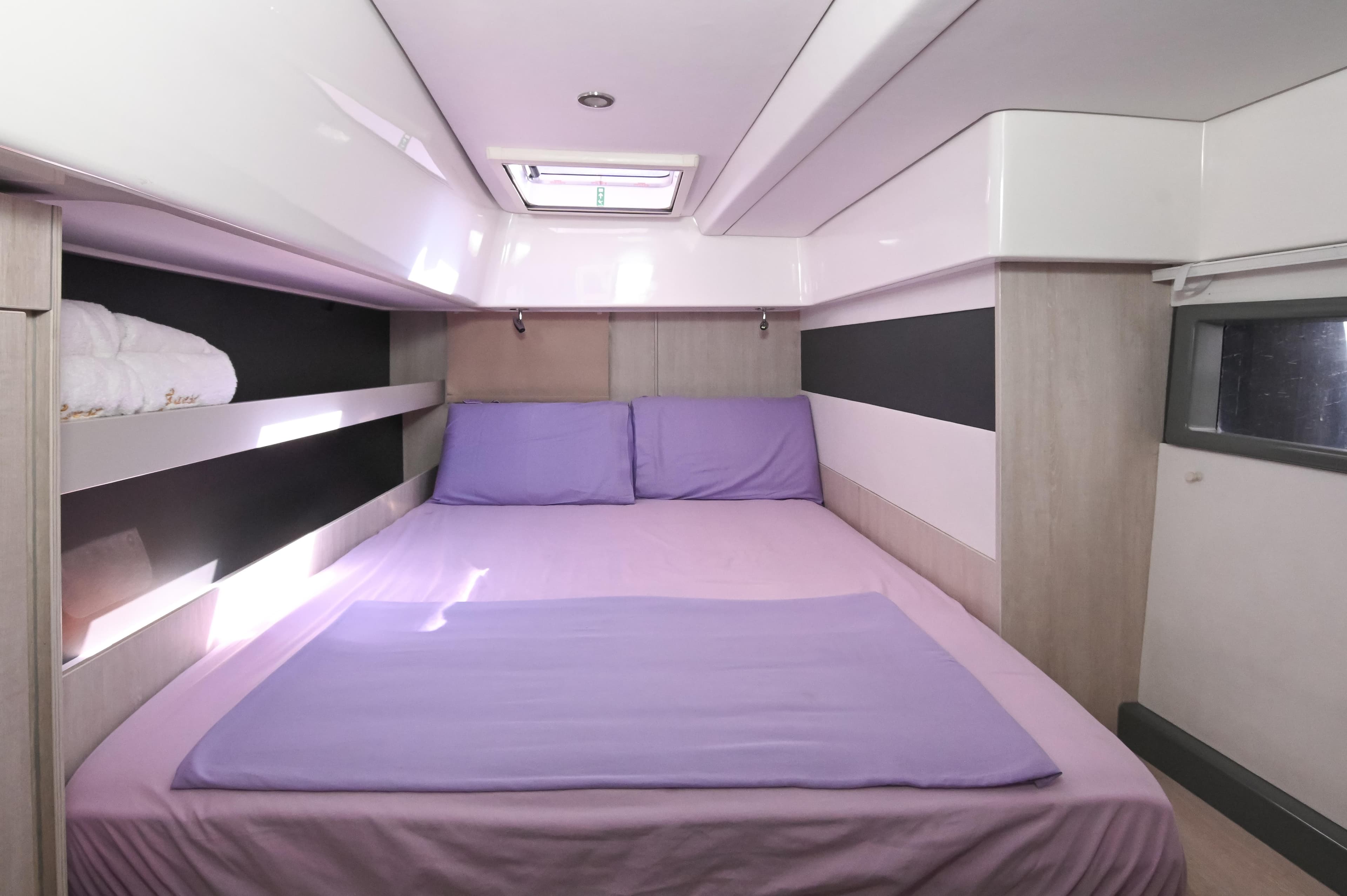 Luxurious bedroom interior of 2017 Leopard 51 Powercat with purple bedding and modern design.