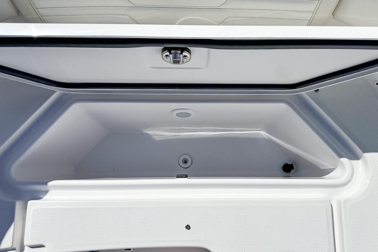 Open storage compartment on 2025 Edgewater 262CX Crossover boat.