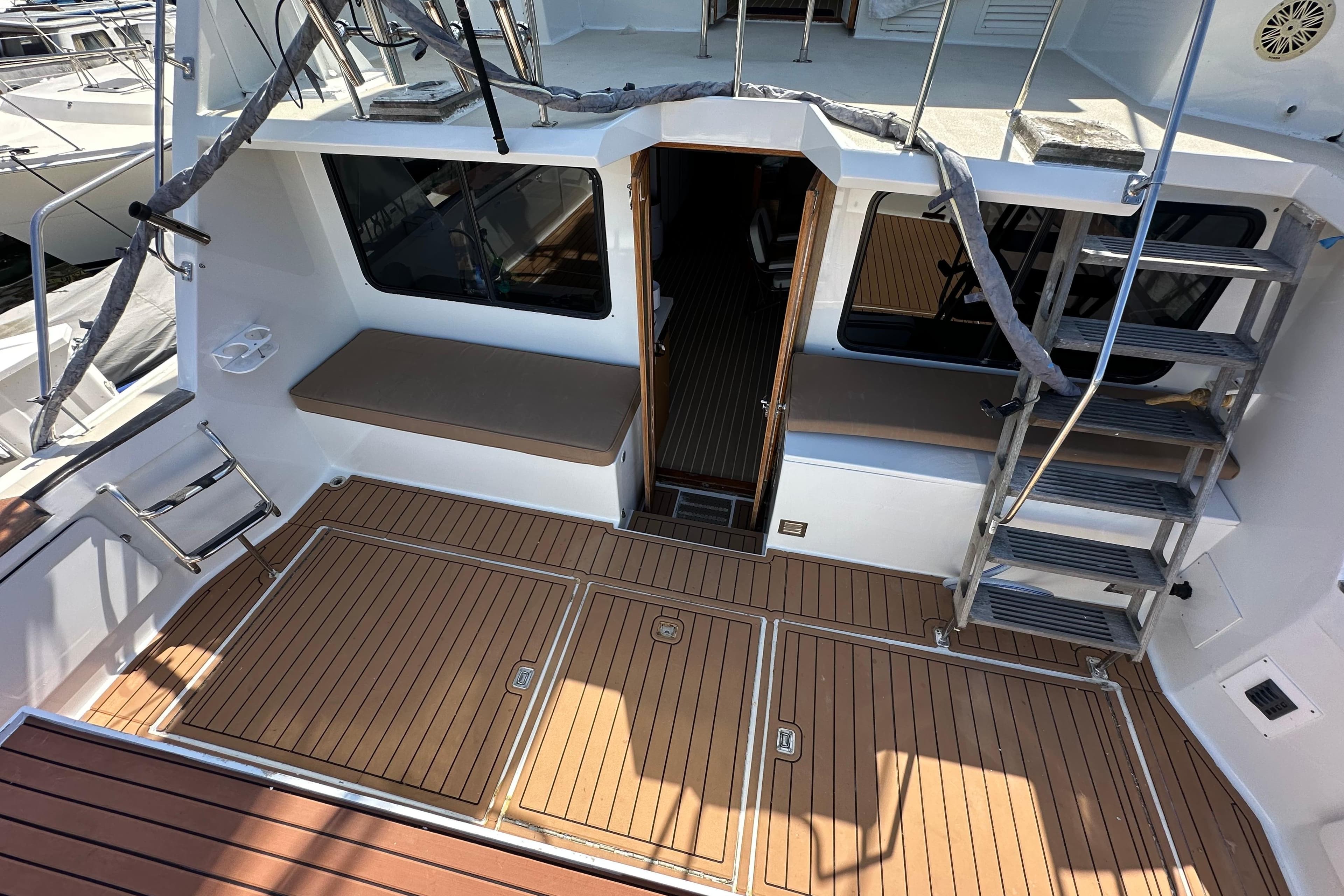 1973 Elliott Yachtfisher deck with wooden flooring and metal stairs.