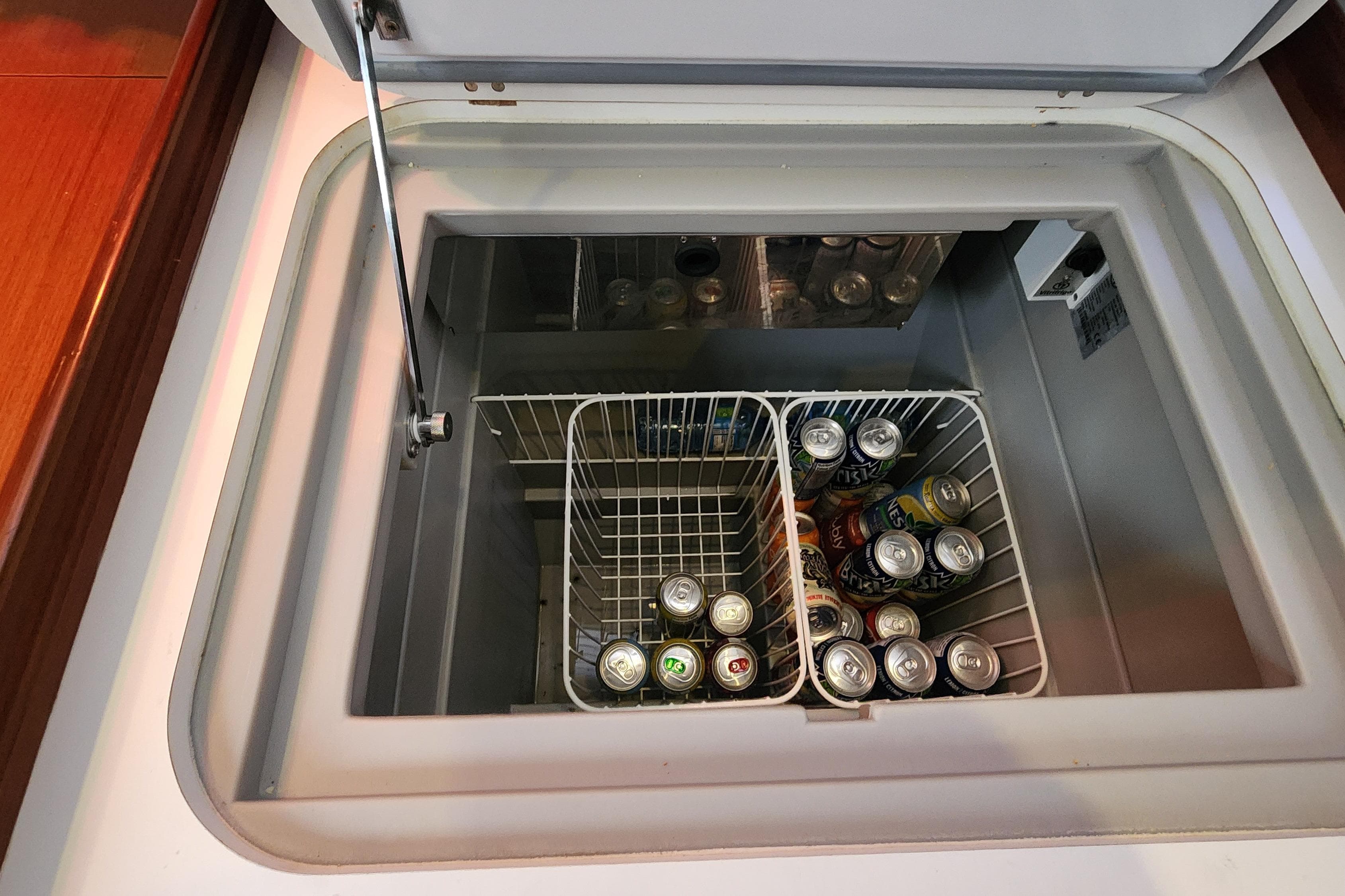 Built-in cooler with assorted drinks on a 2012 Beneteau Oceanis 40 yacht.