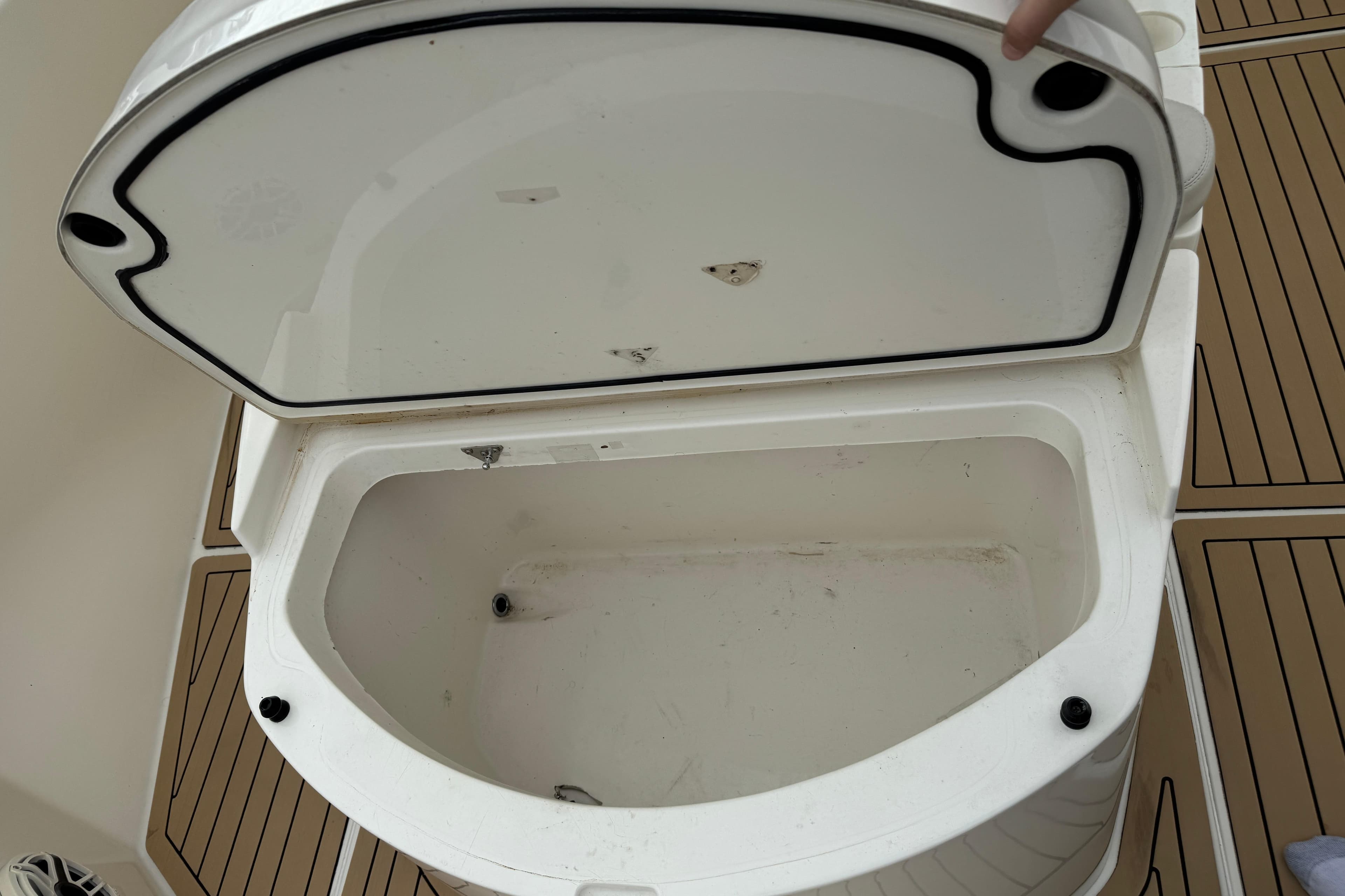 Open storage compartment on 2015 Cobia 344 Center Console boat.