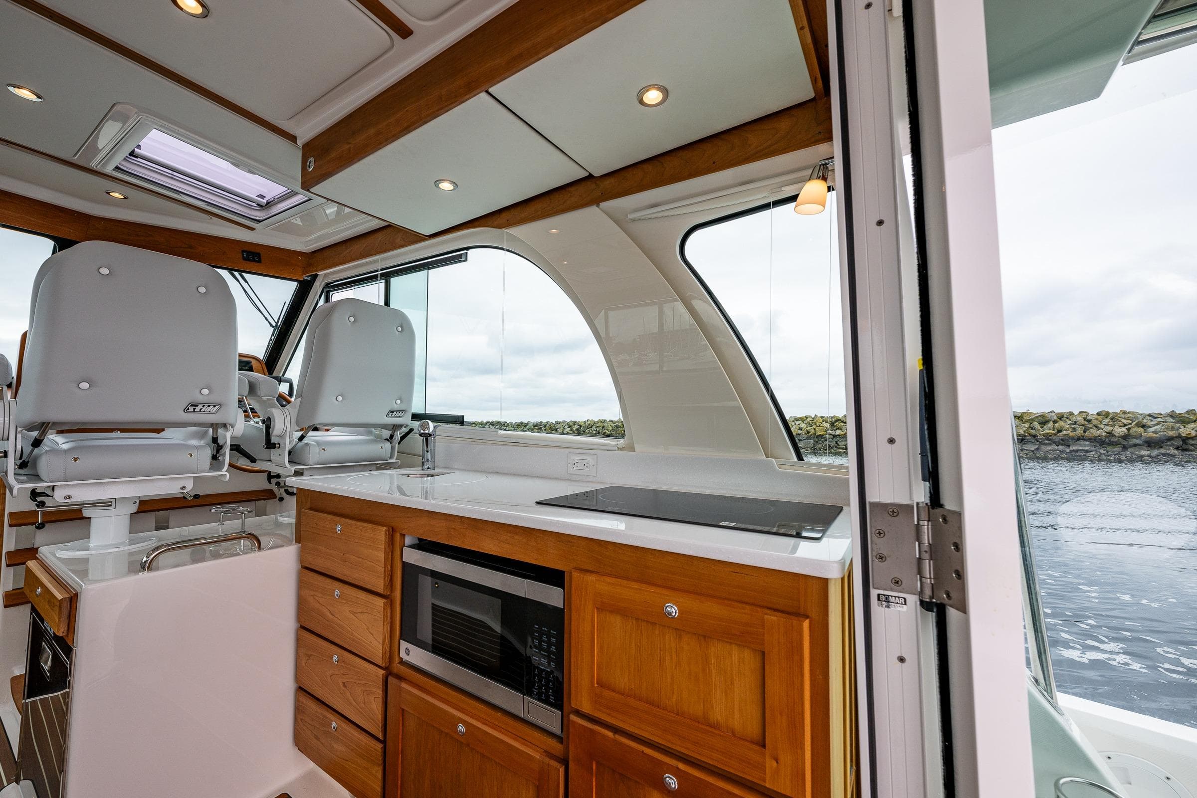 Interior of 2025 Back Cove 39O yacht with modern kitchen and seating area.
