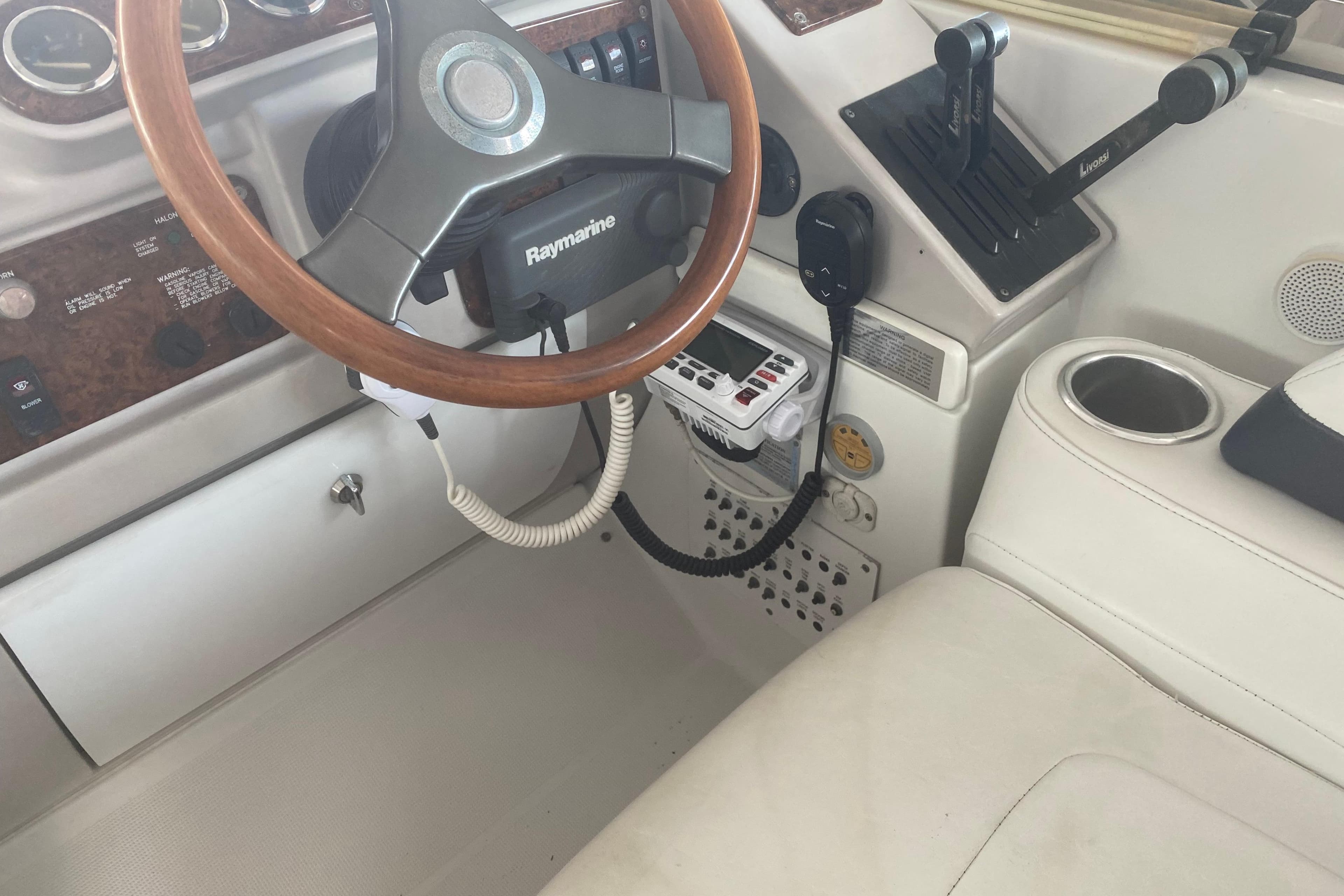 2005 Formula boat cockpit with Raymarine steering, controls, and communication equipment.