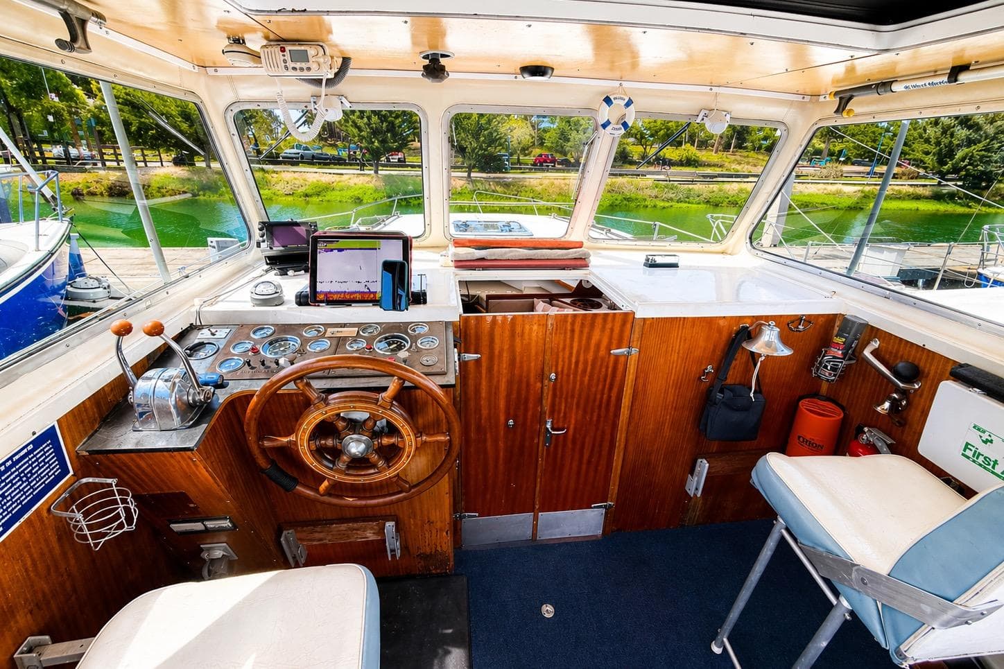 1975 Apollo 32 Deluxe TT boat cockpit with vintage steering wheel and control panel.