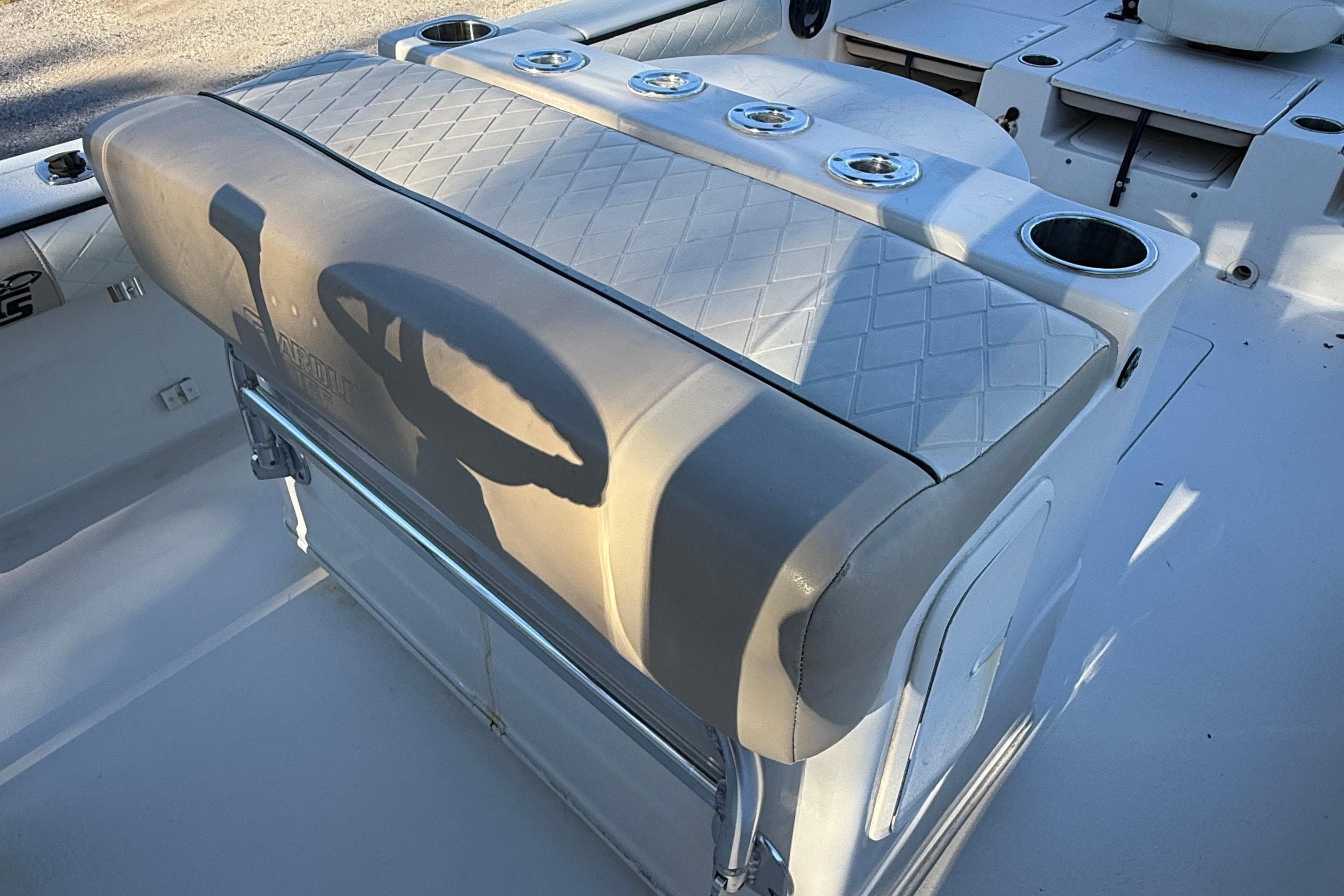 2021 Carolina Skiff 26 Ultra Elite boat interior with cushioned seating and cup holders.