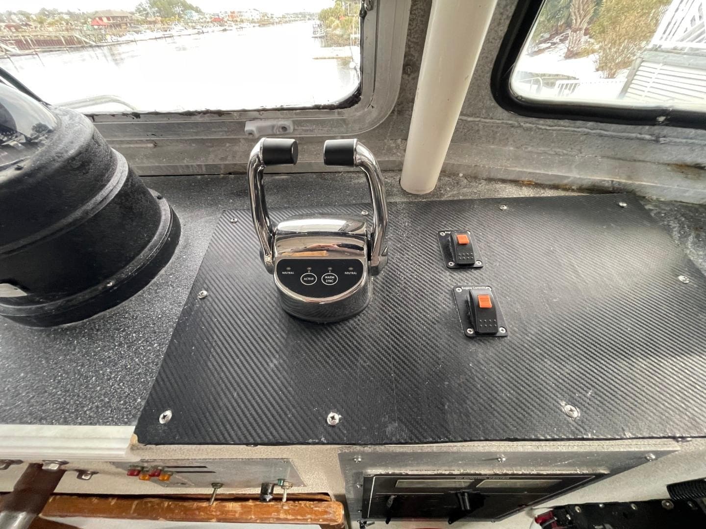 Control panel of a 1972 Swiftships Commercial Passenger vessel, featuring throttle and switches.