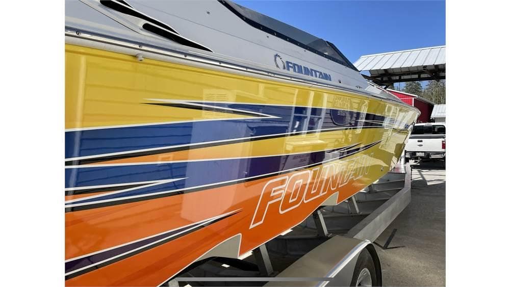 Colorful 2006 Fountain 42 boat with vibrant stripes on a trailer.