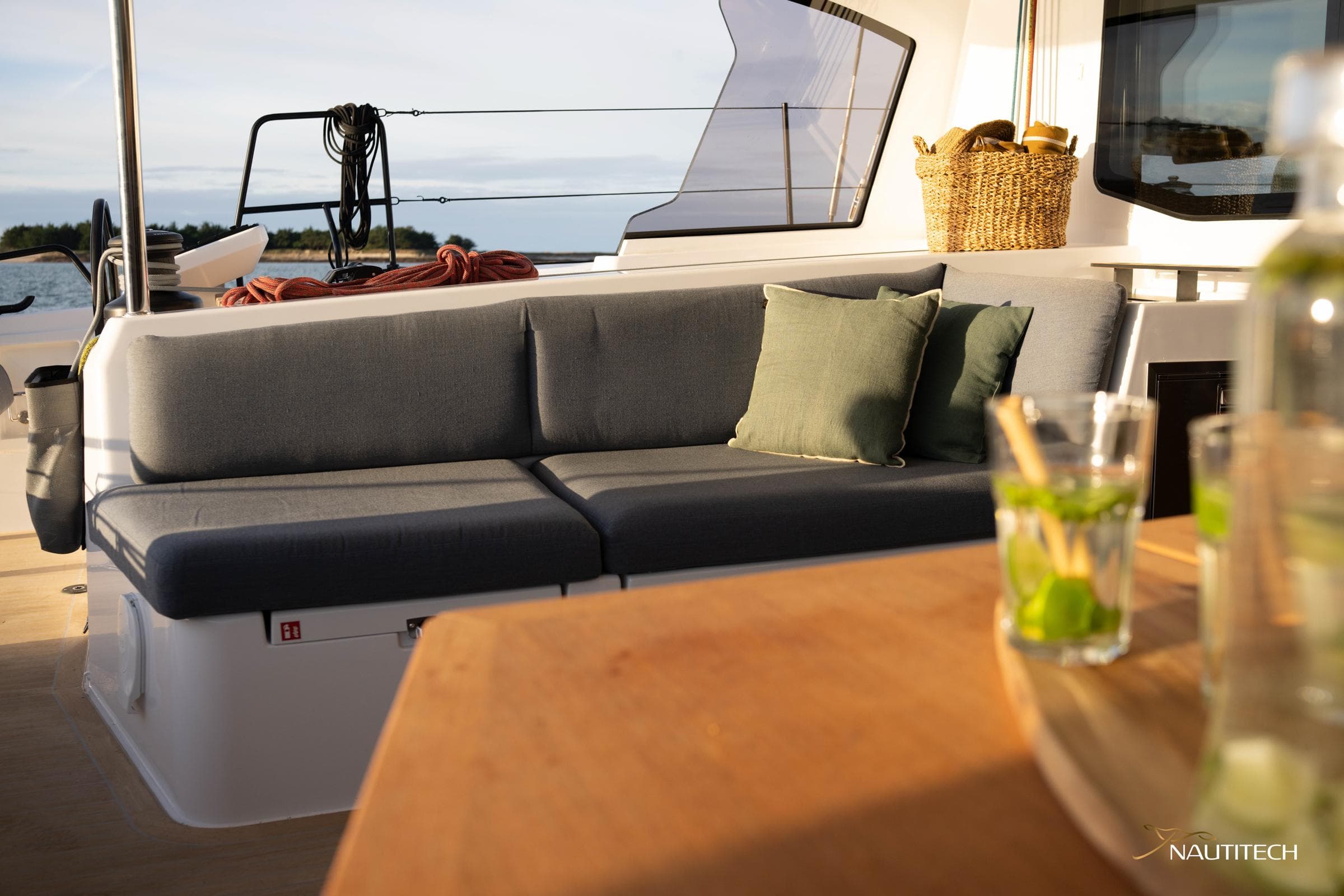 Luxurious seating area on 2025 Nautitech 48 Open catamaran with cushions and drinks.