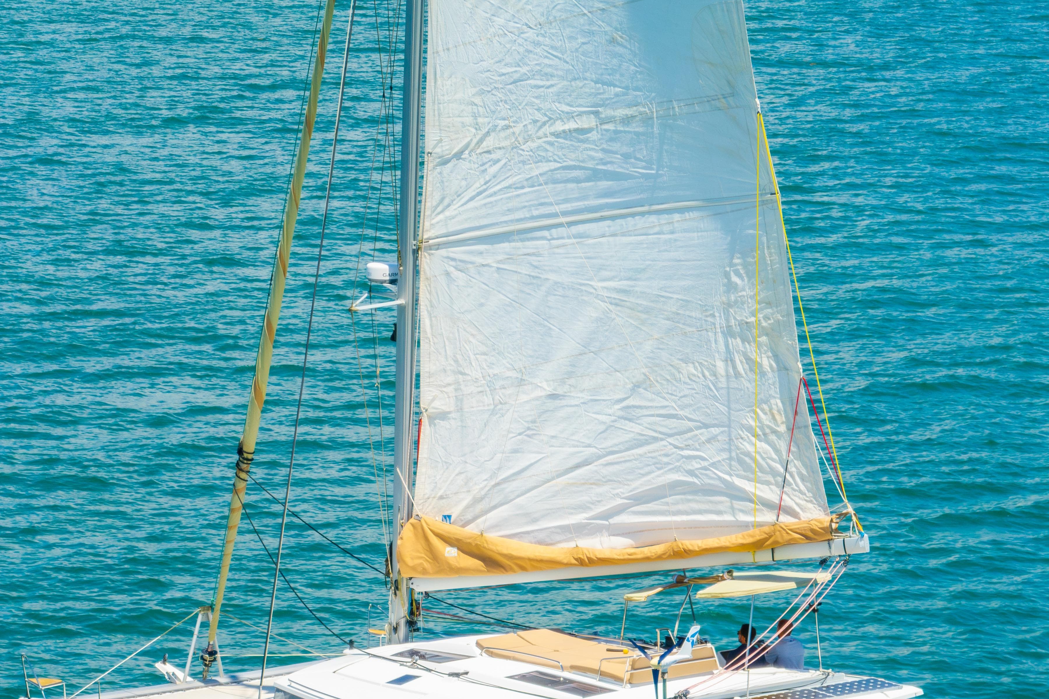 Sailing catamaran Fountaine Pajot Helia 44, 2014 model, on blue ocean waters.
