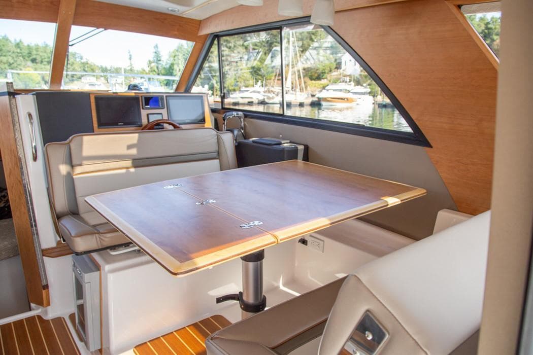 Manufacturer Provided Image: Interior of 2020 Cutwater C-32 C boat with dining table and seating area.