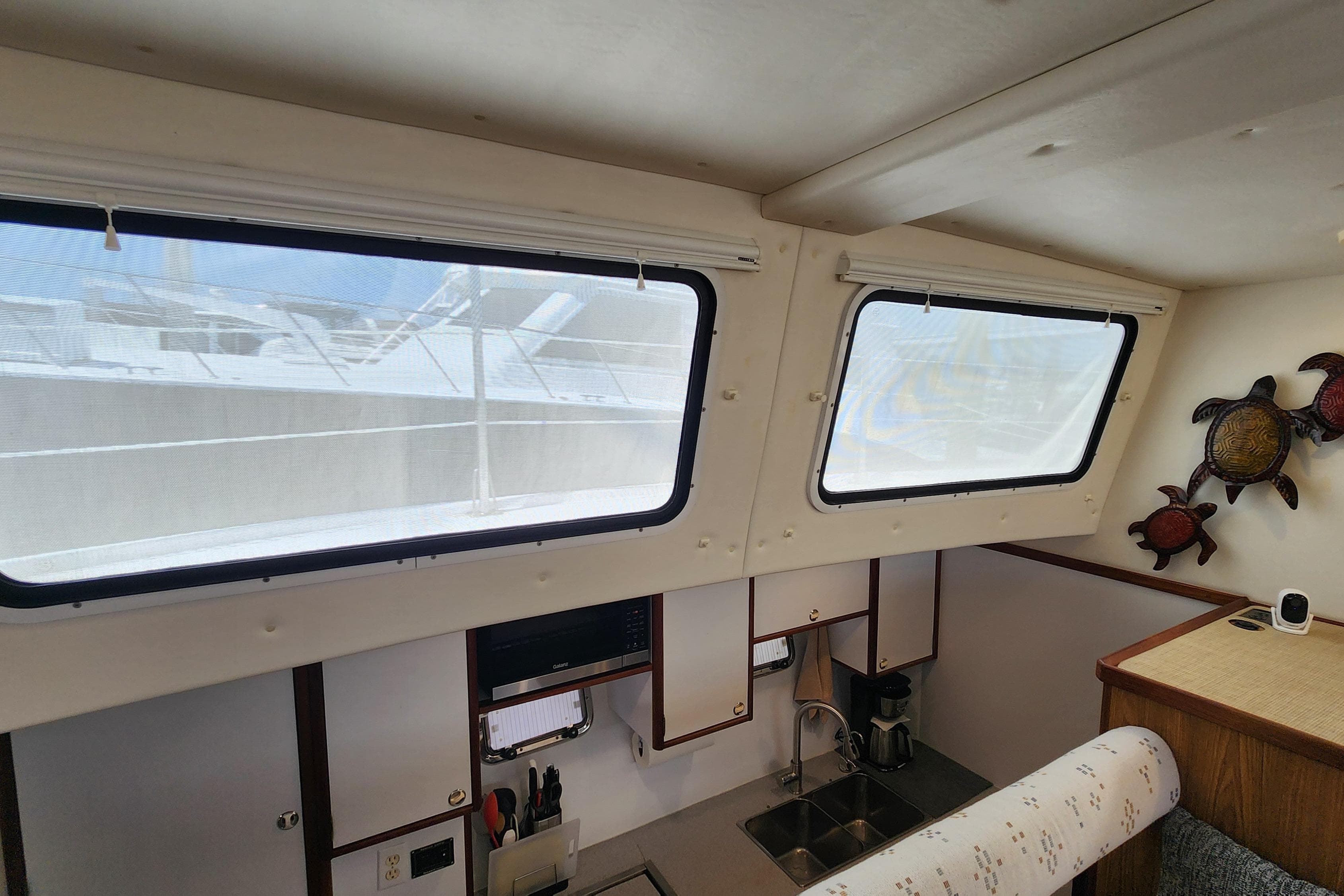 Interior of 2003 Endeavour 44 TrawlerCat with kitchen and decorative wall art.