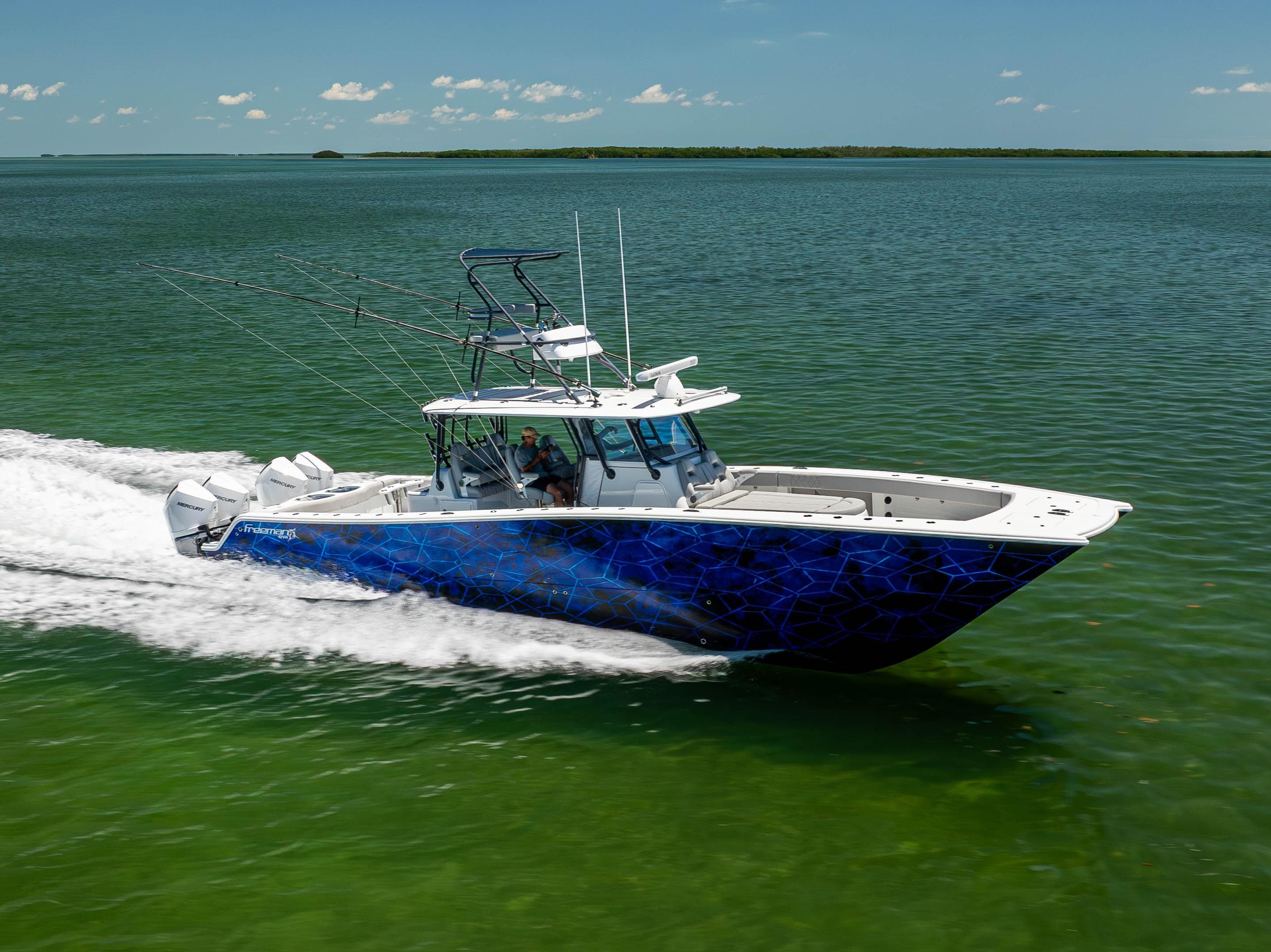 2021 Freeman 42 LR boat cruising on open water, vibrant blue design, clear sky.