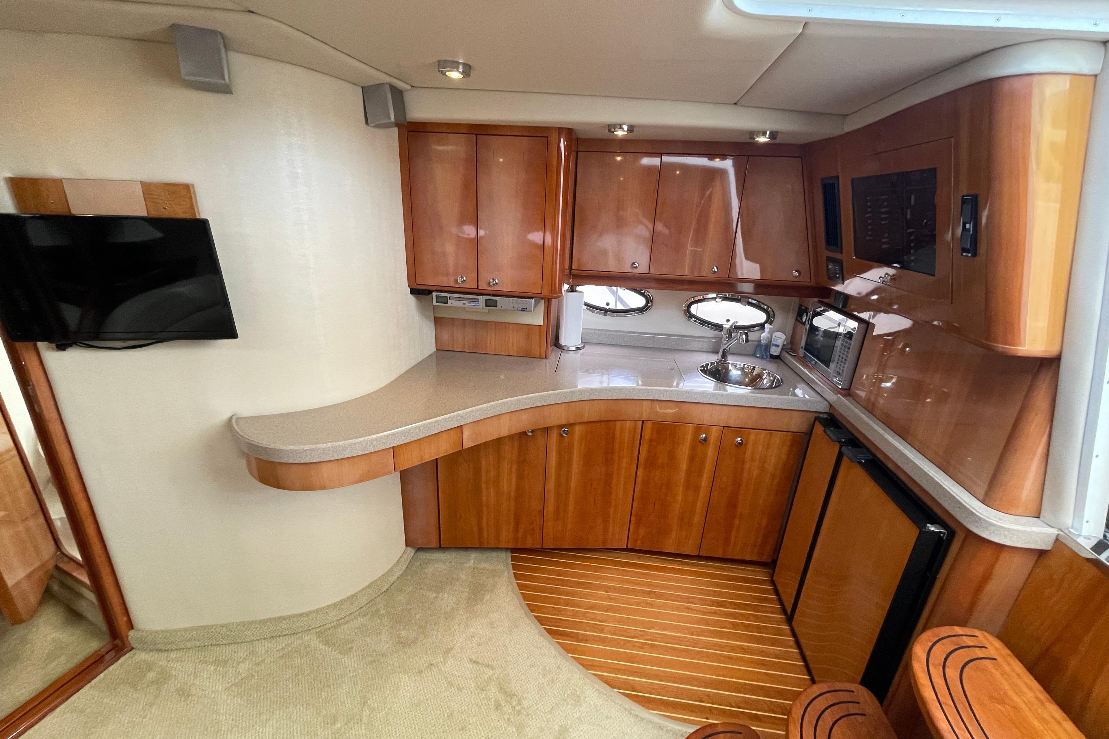Luxurious 2004 Regal Commodore 4260 yacht interior with modern kitchen and sleek wood finishes.