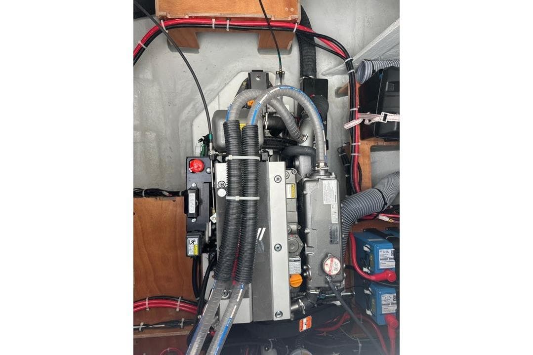 Engine compartment of a 2025 Lagoon 43 boat, showcasing mechanical components and wiring.