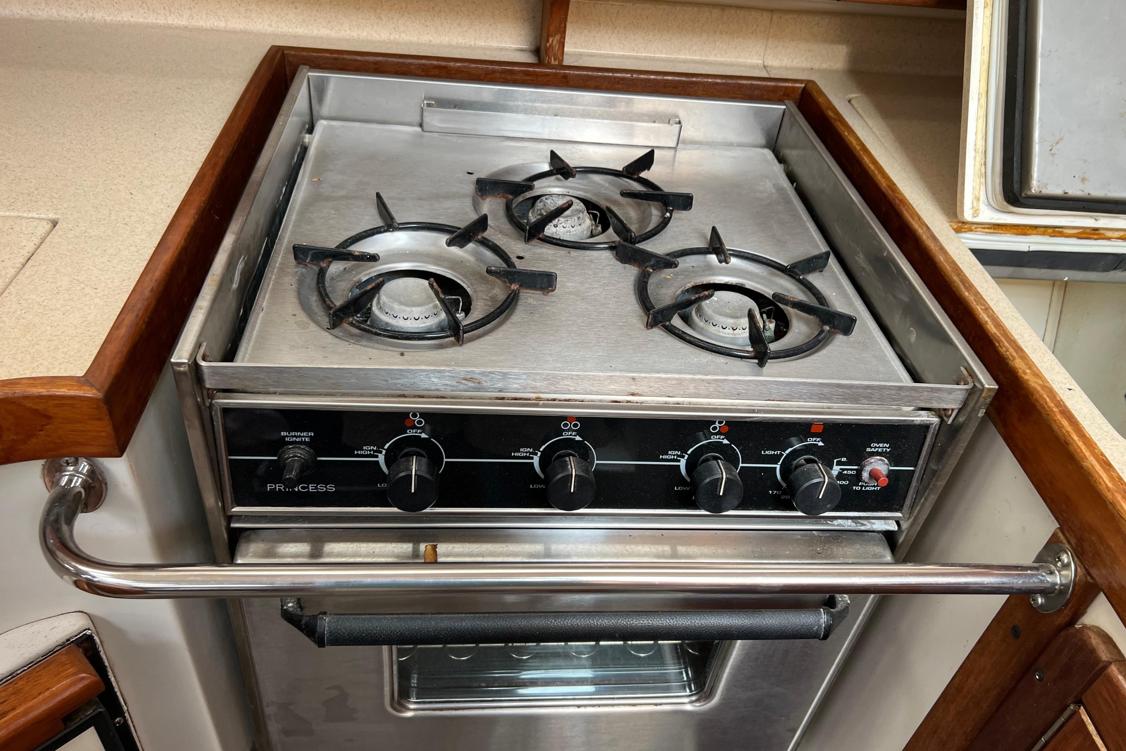 Stainless steel stove with three burners on a 1997 Catalina 400 yacht.