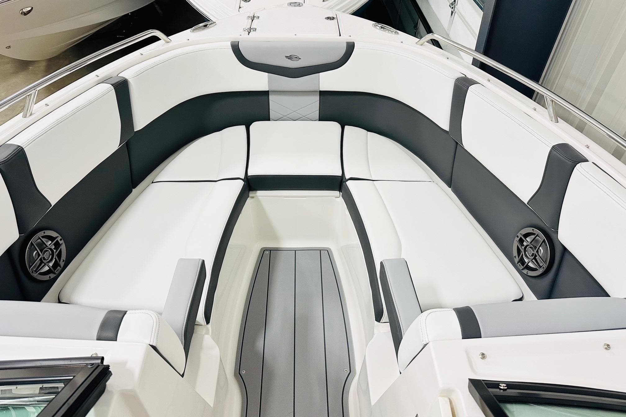 2026 Chaparral 270 OSX boat interior with sleek white and gray seating.