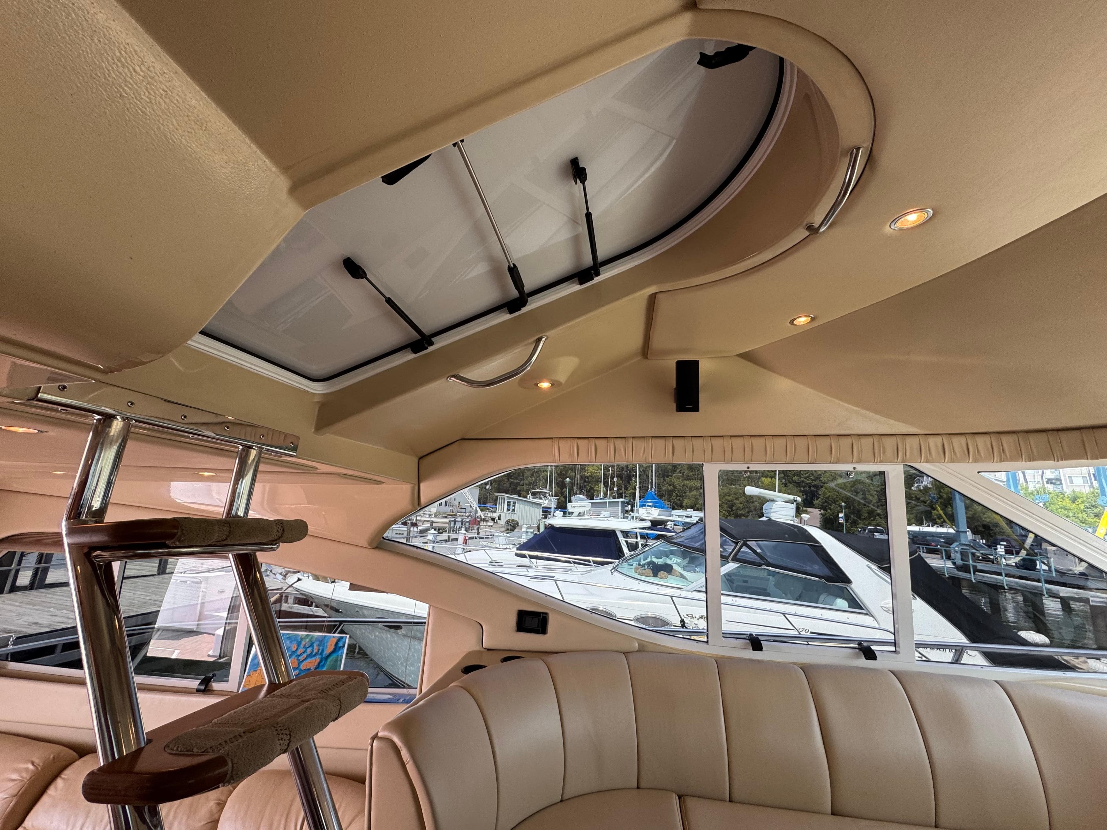 Interior of 2003 Cruisers Yachts 5000 Sedan Sport with skylight and marina view.